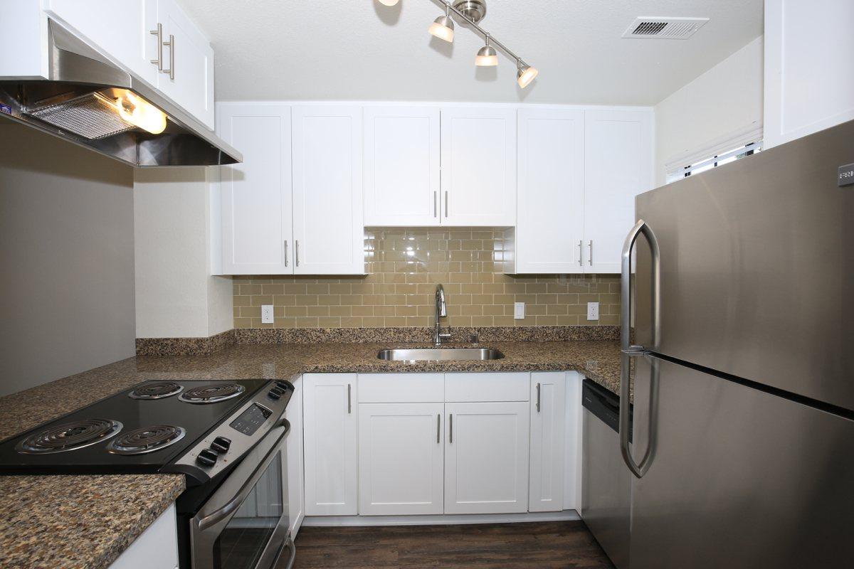 a stove top oven sitting inside of a kitchen