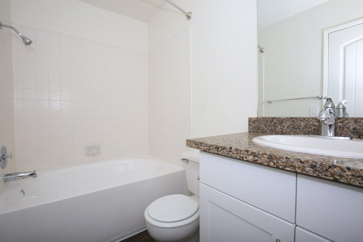 a large white tub next to a sink