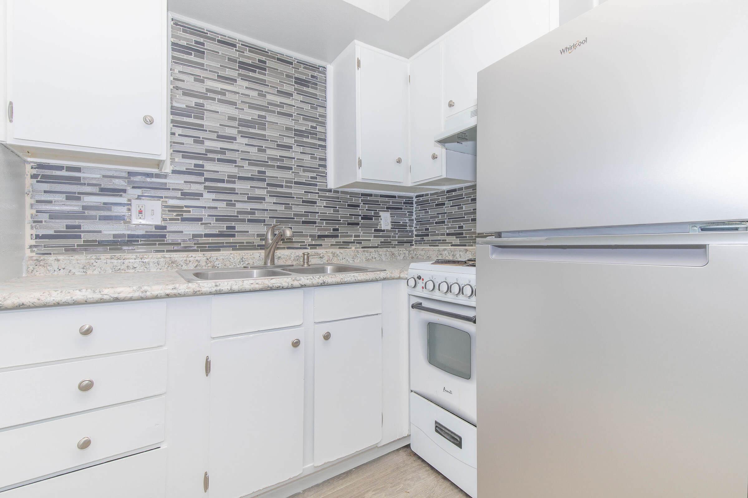 a kitchen with a stove and a refrigerator