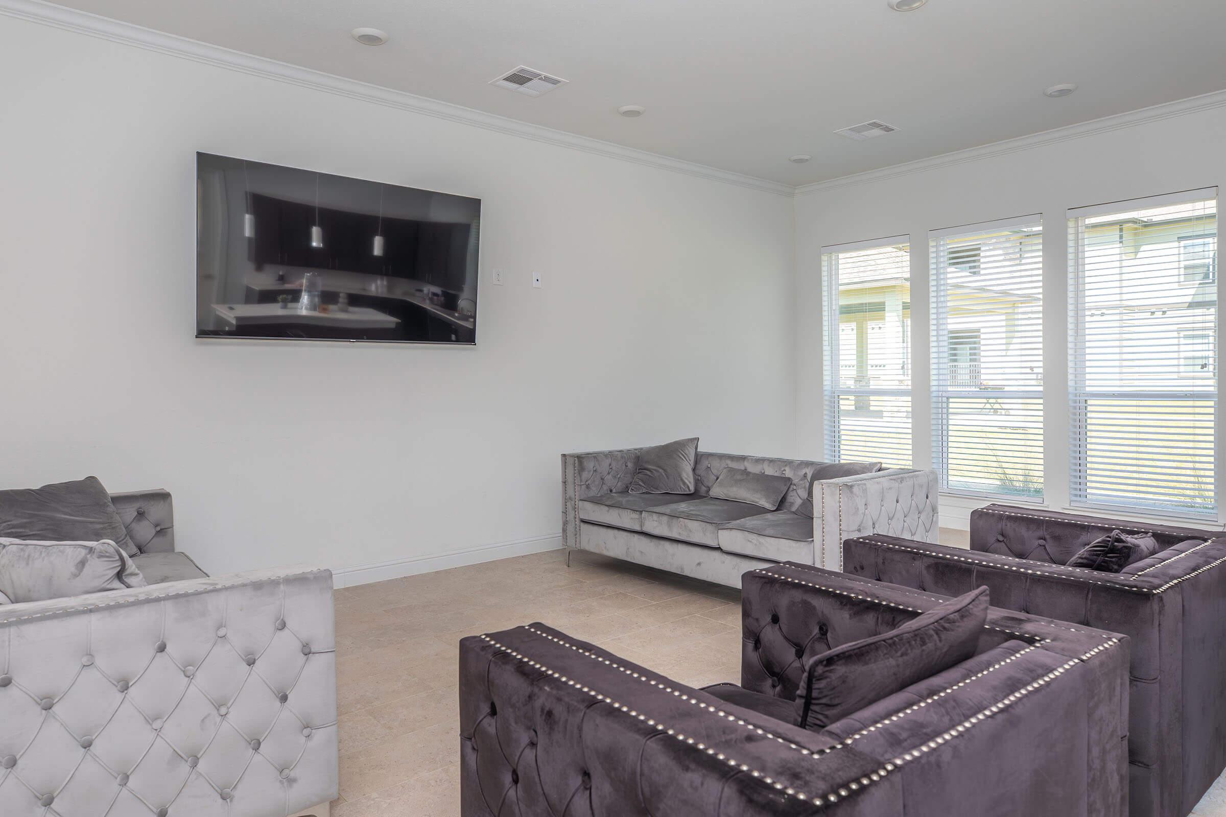 a living room filled with furniture and a large window