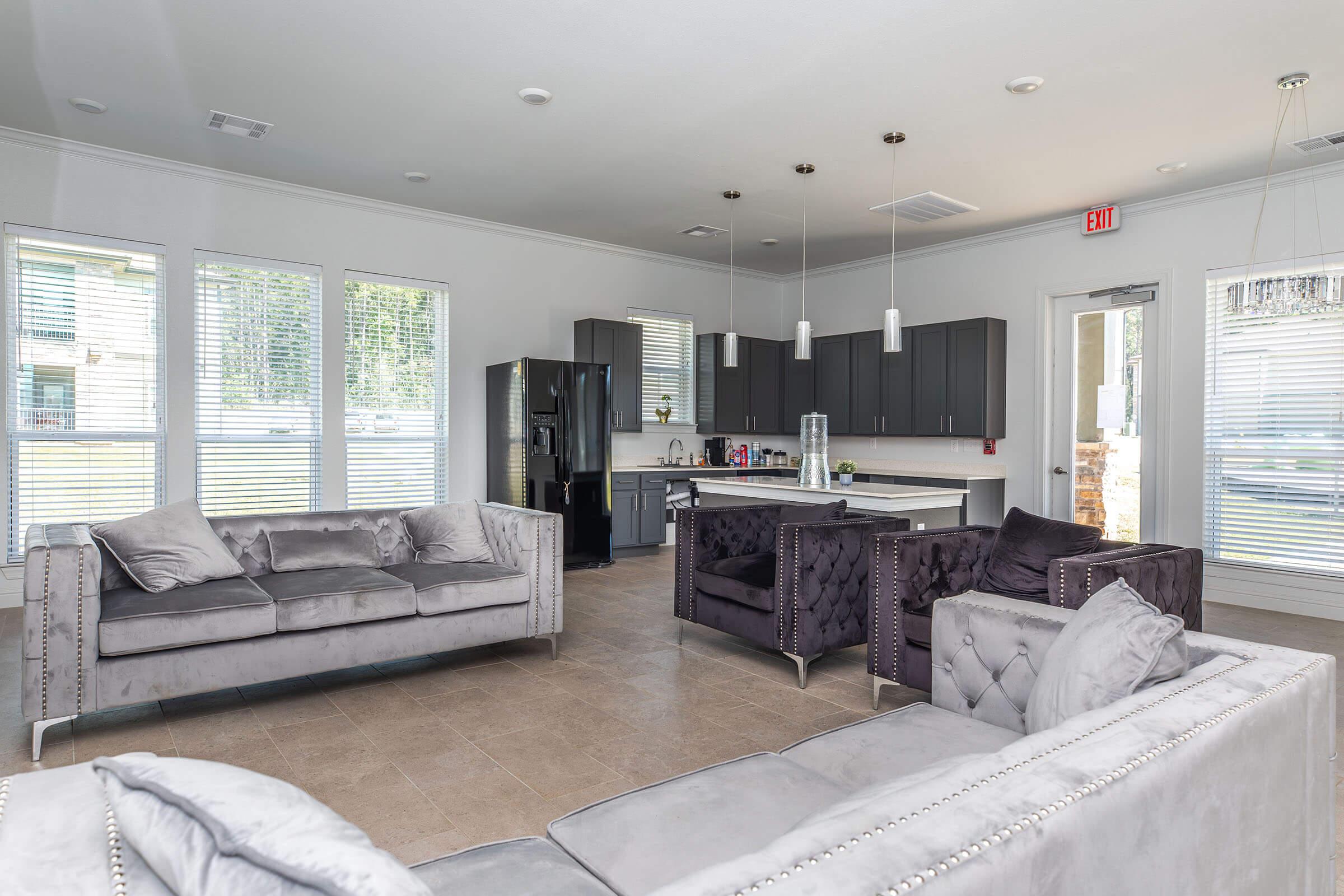 a living room filled with furniture and a large window