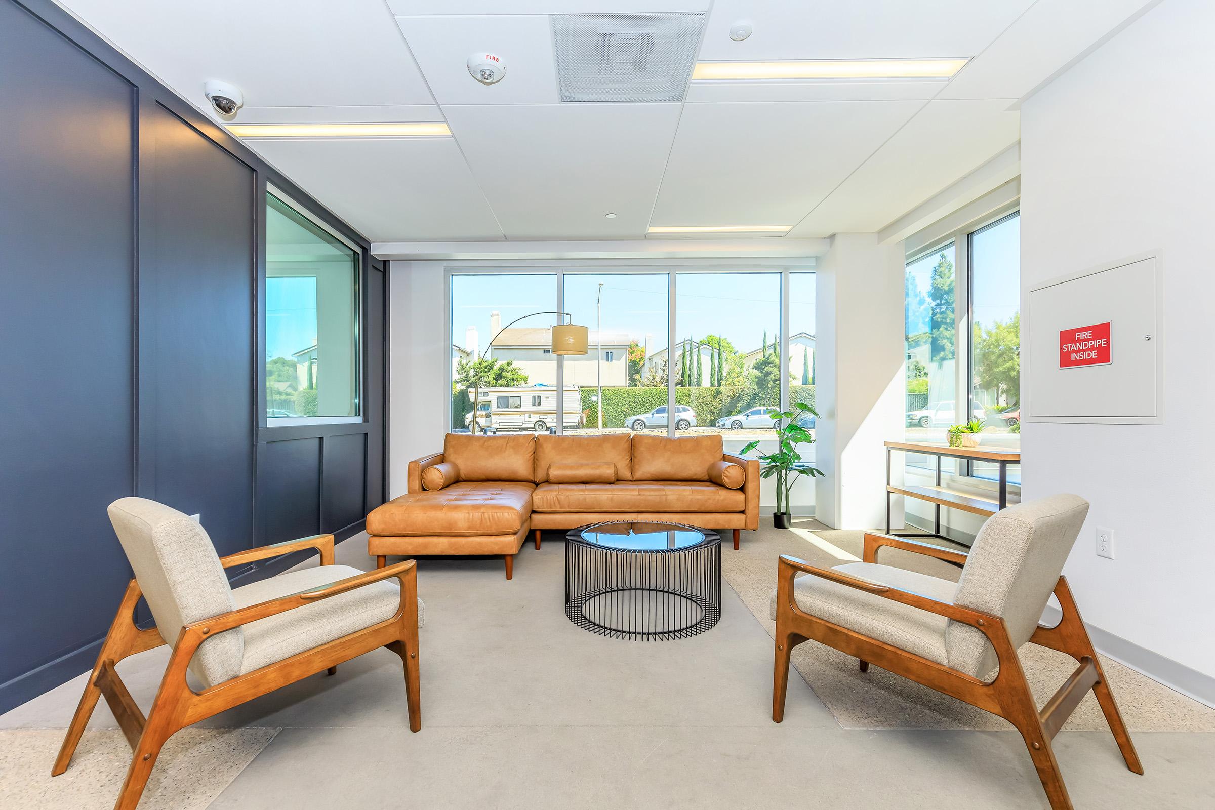 a living room filled with furniture and a large window