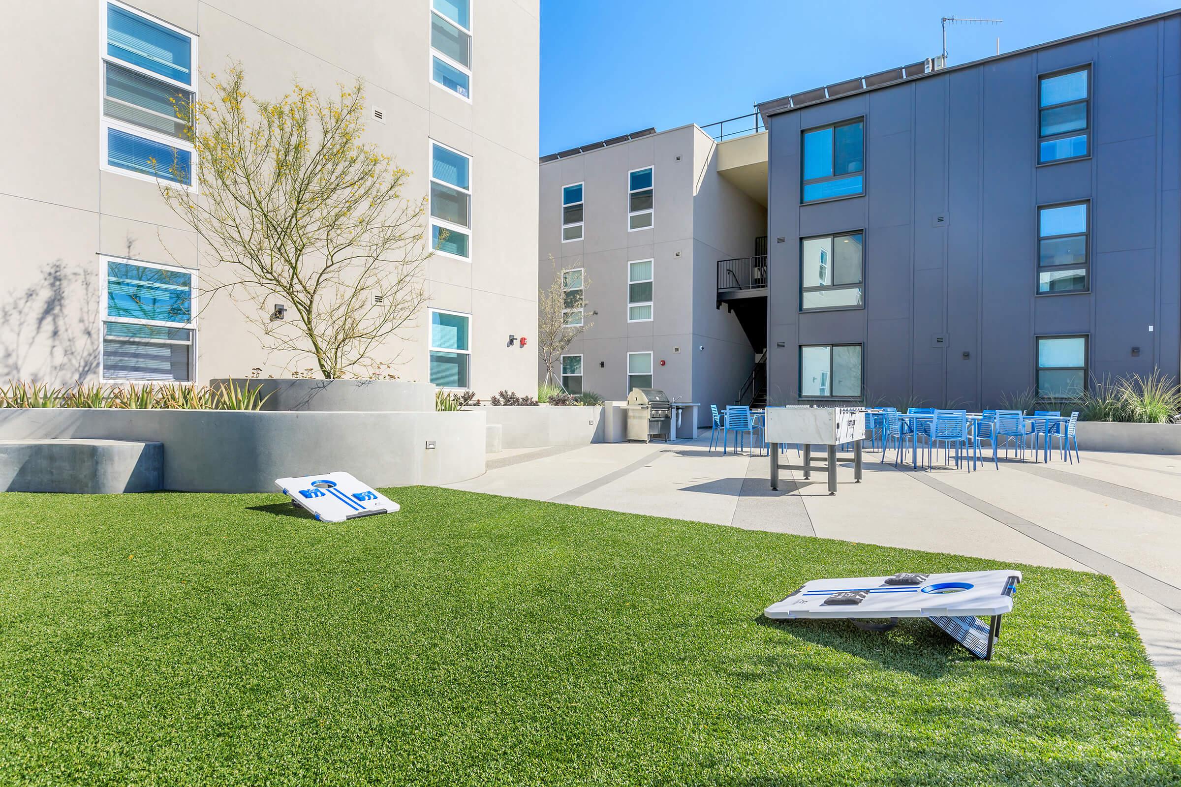 a person lying on grass near a building