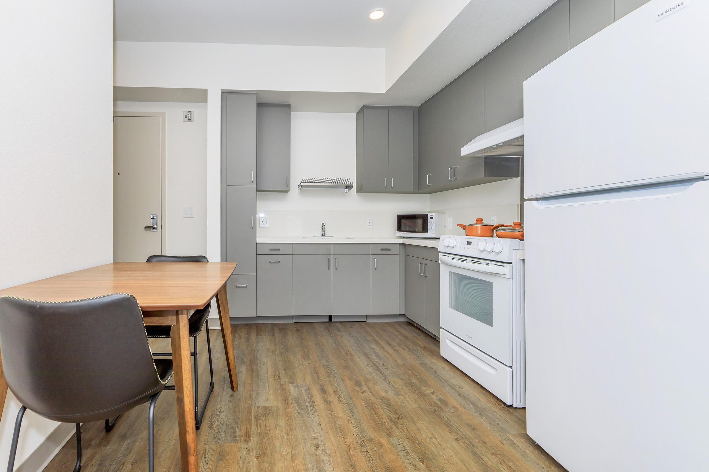 a kitchen with a stove and a refrigerator