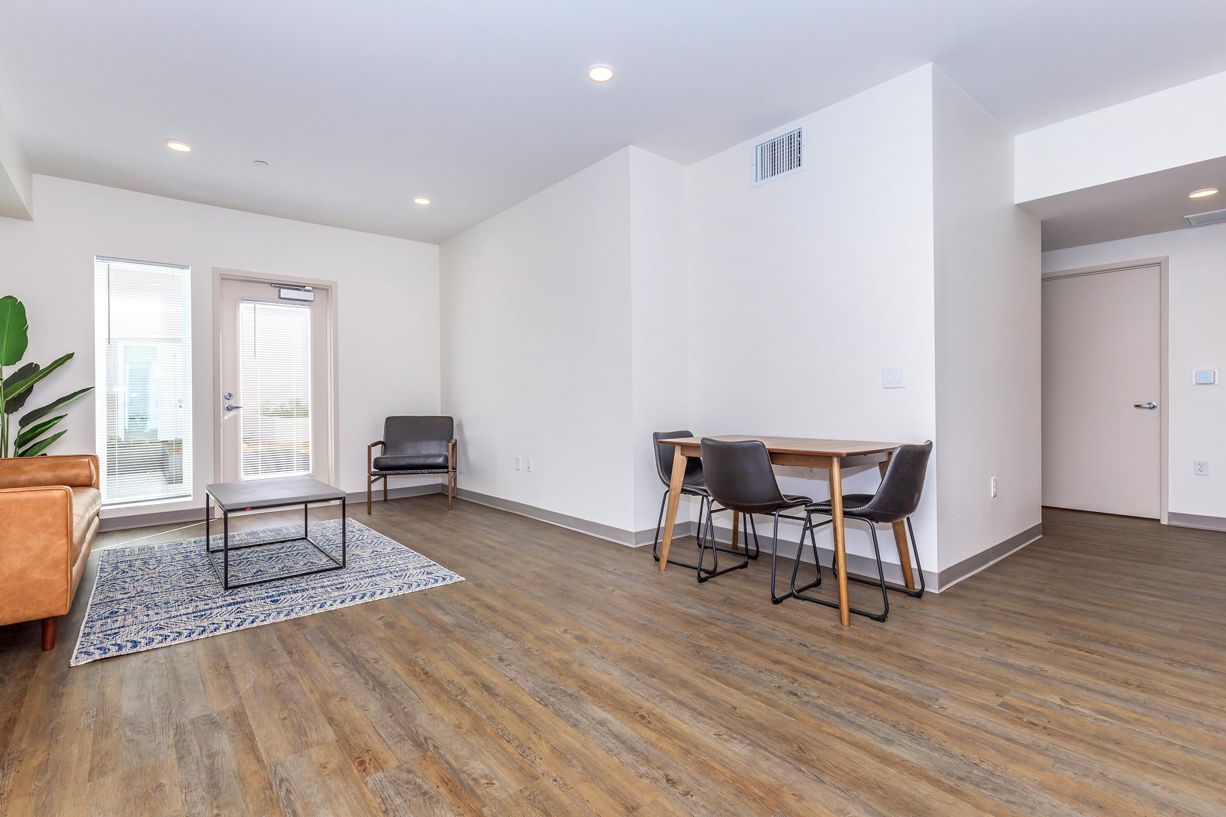 a living room filled with furniture and a large window