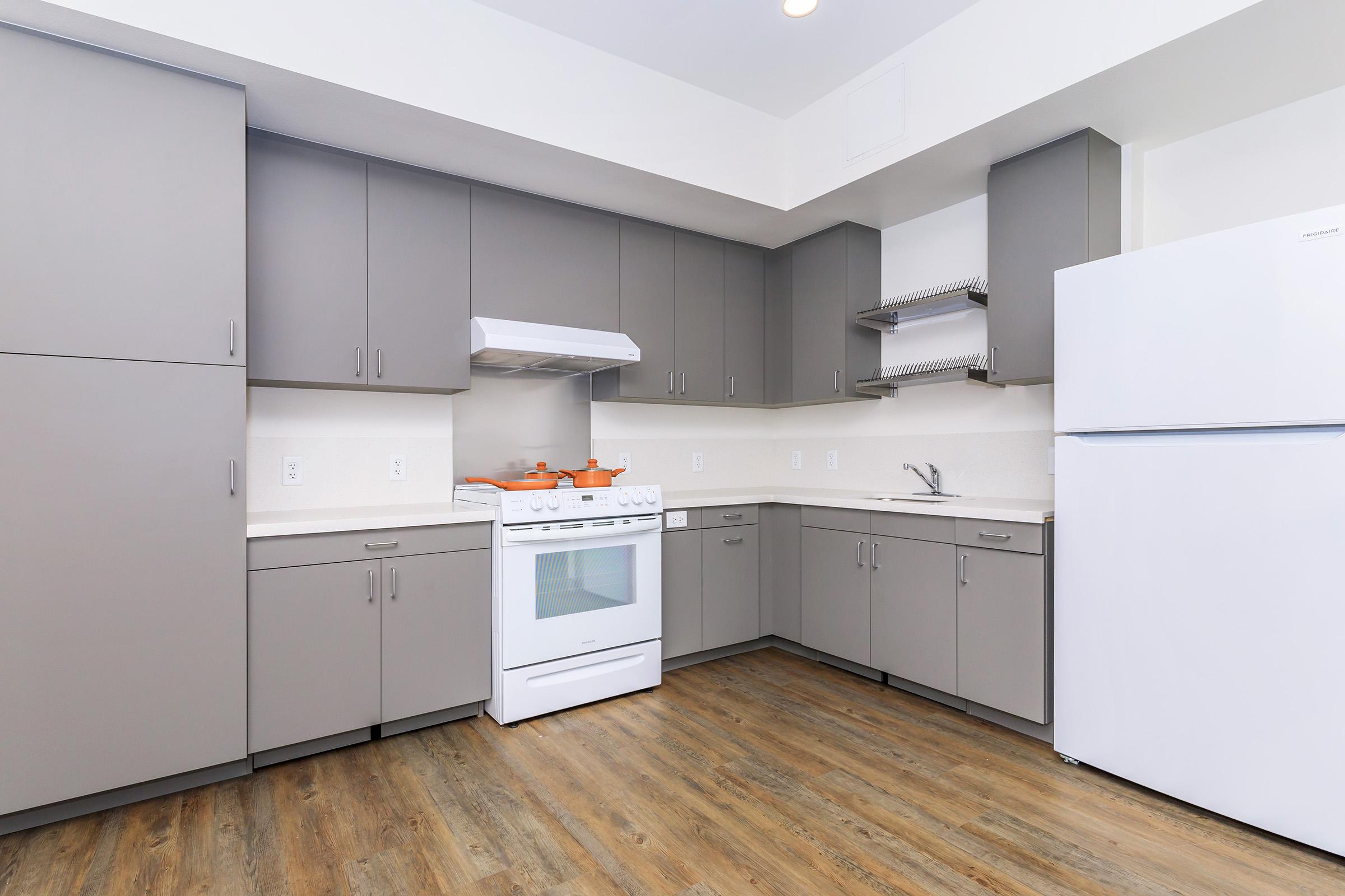 a kitchen with a stove and a refrigerator