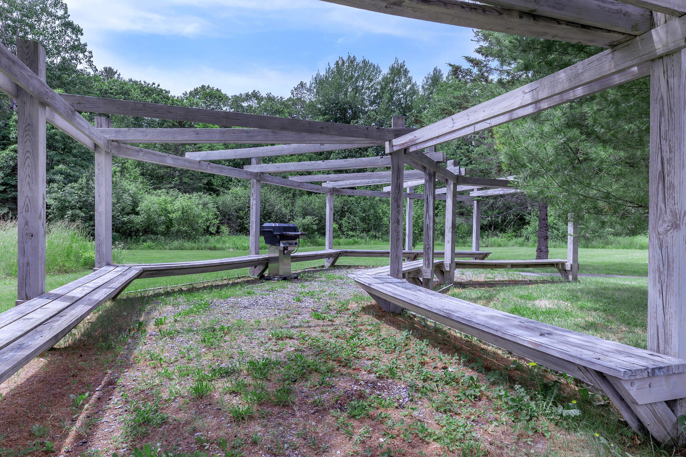 a wooden bench near a bridge