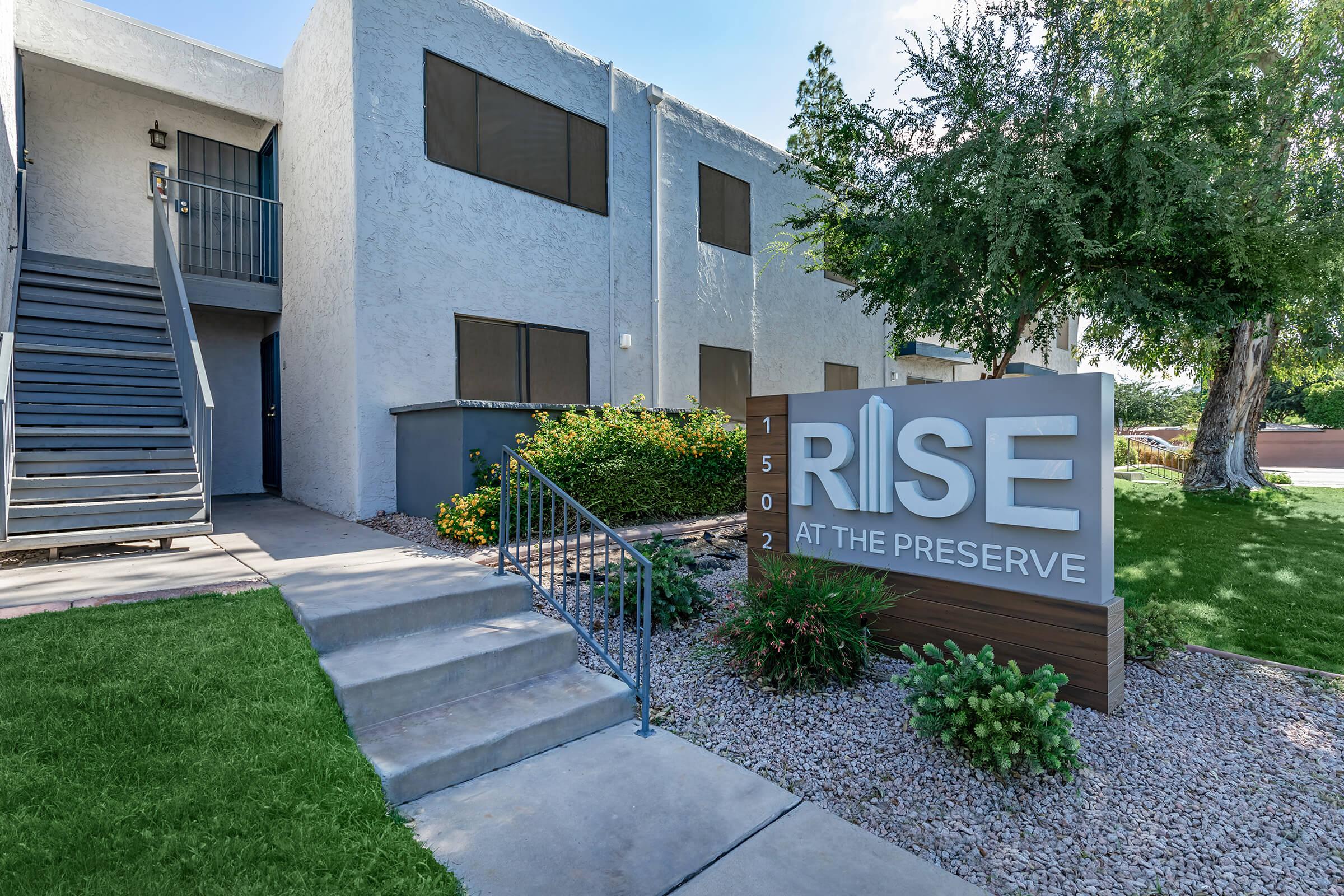 Rise at the Preserve signage outside of a large apartment building and walkway