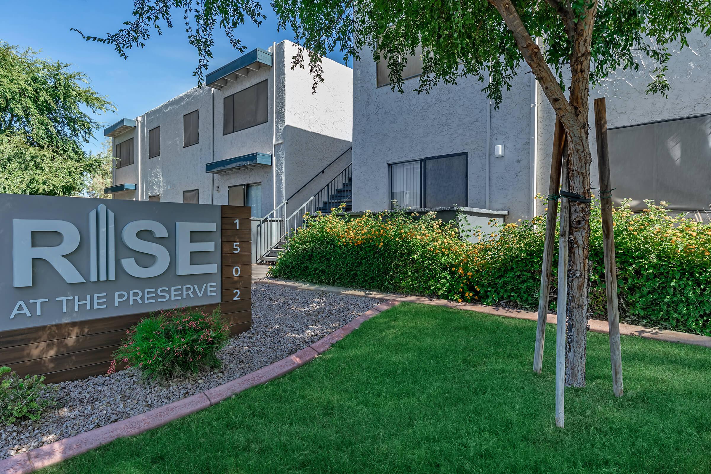 Outdoor view of the Rise at the Preserve sign in front of an apartment building
