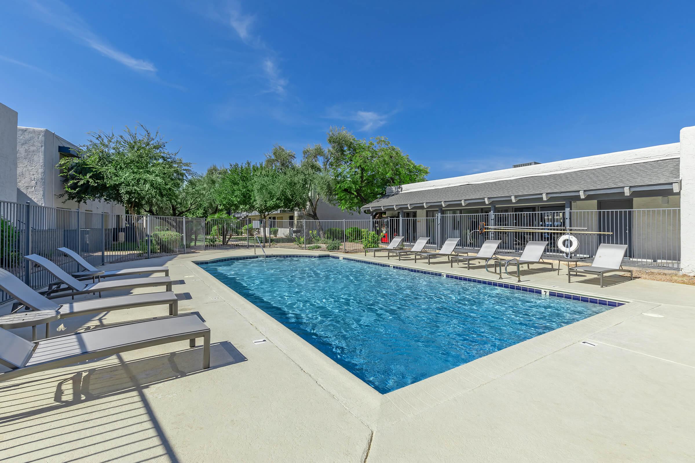 The pool area surrounded by loungers at Rise at the Preserve in North Phoenix, AZ.