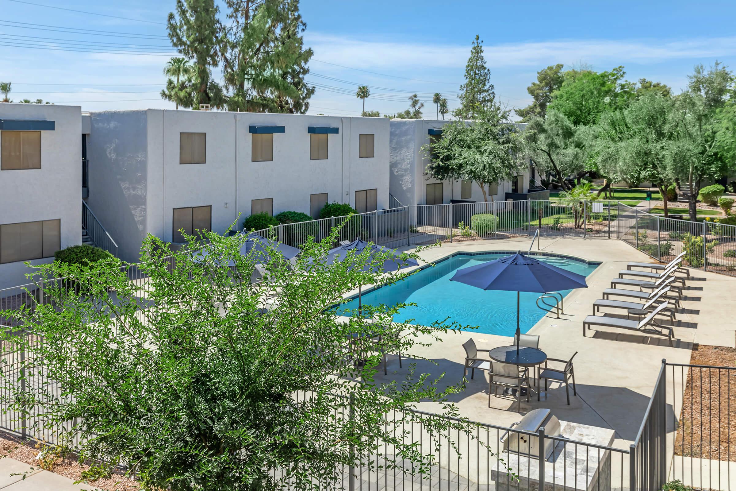 The pool area surrounded by the apartments at Rise at The Preserve in North Phoenix, AZ.