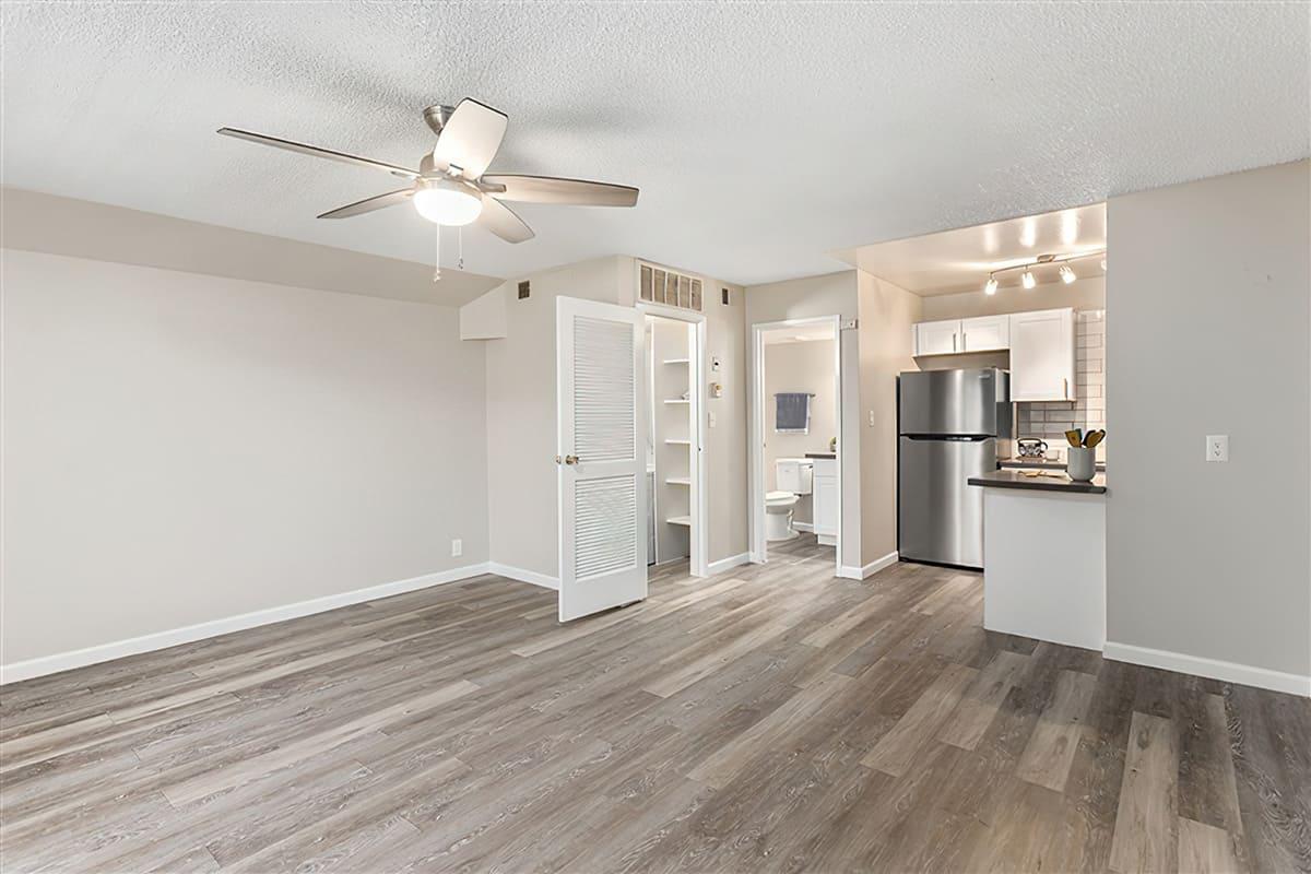 The open-concept living area with a kitchen, bathroom, and laundry room at Rise at the Preserve.