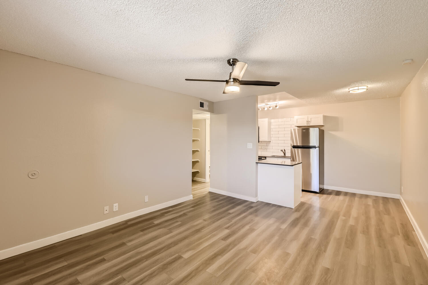 A Rise at the Preserve apartment with wood-style floors and a kitchen.