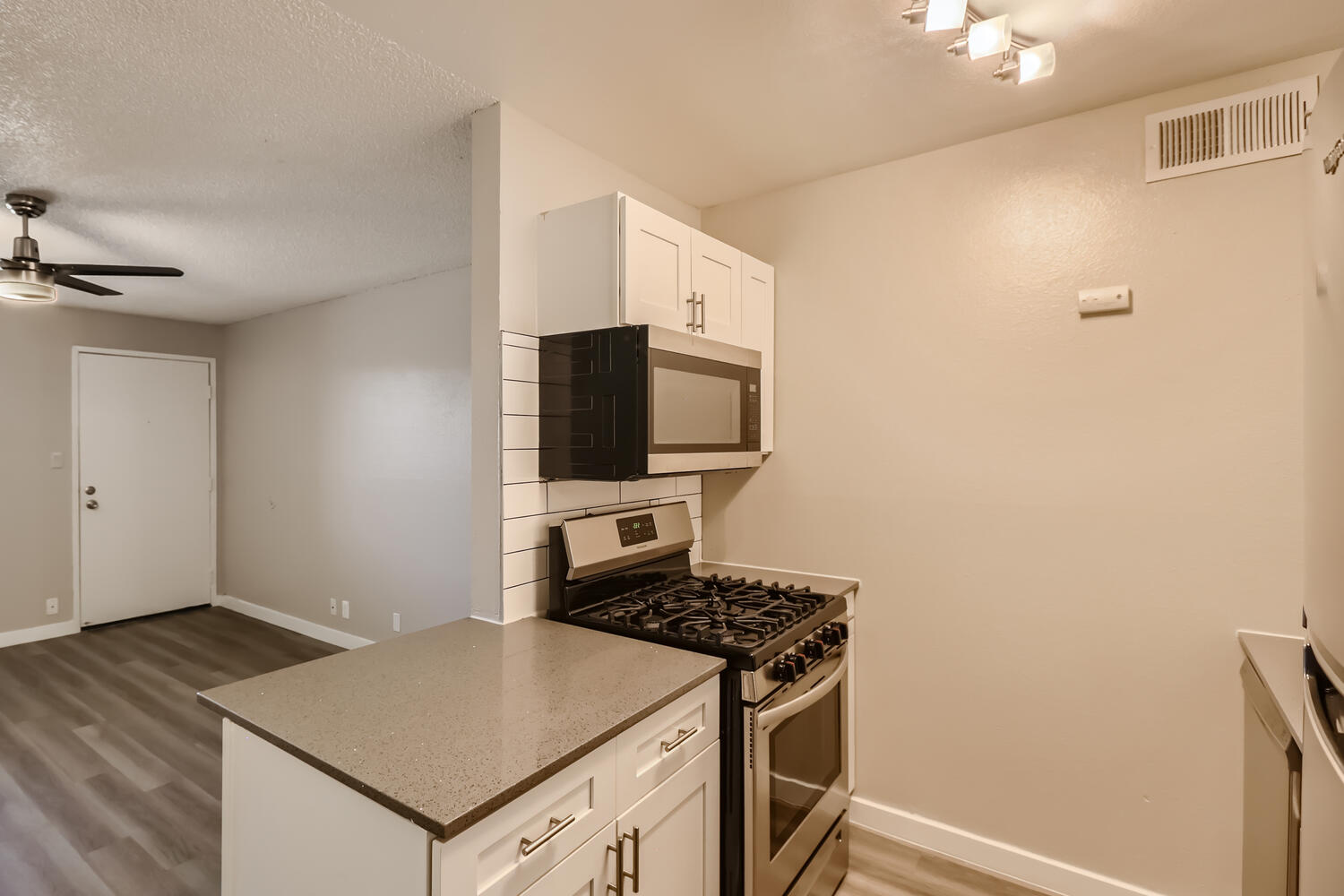 A kitchen at Rise at the Preserve with stainless steel appliances and shaker cabinets.