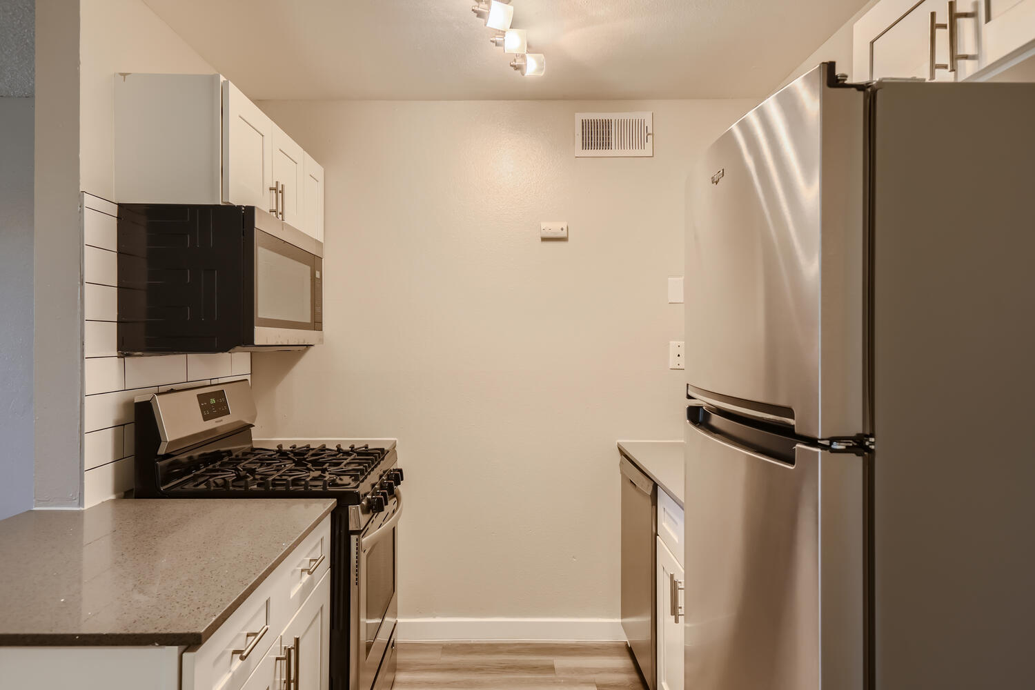 A kitchen at Rise at the Preserve with stainless steel appliances and shaker cabinets.