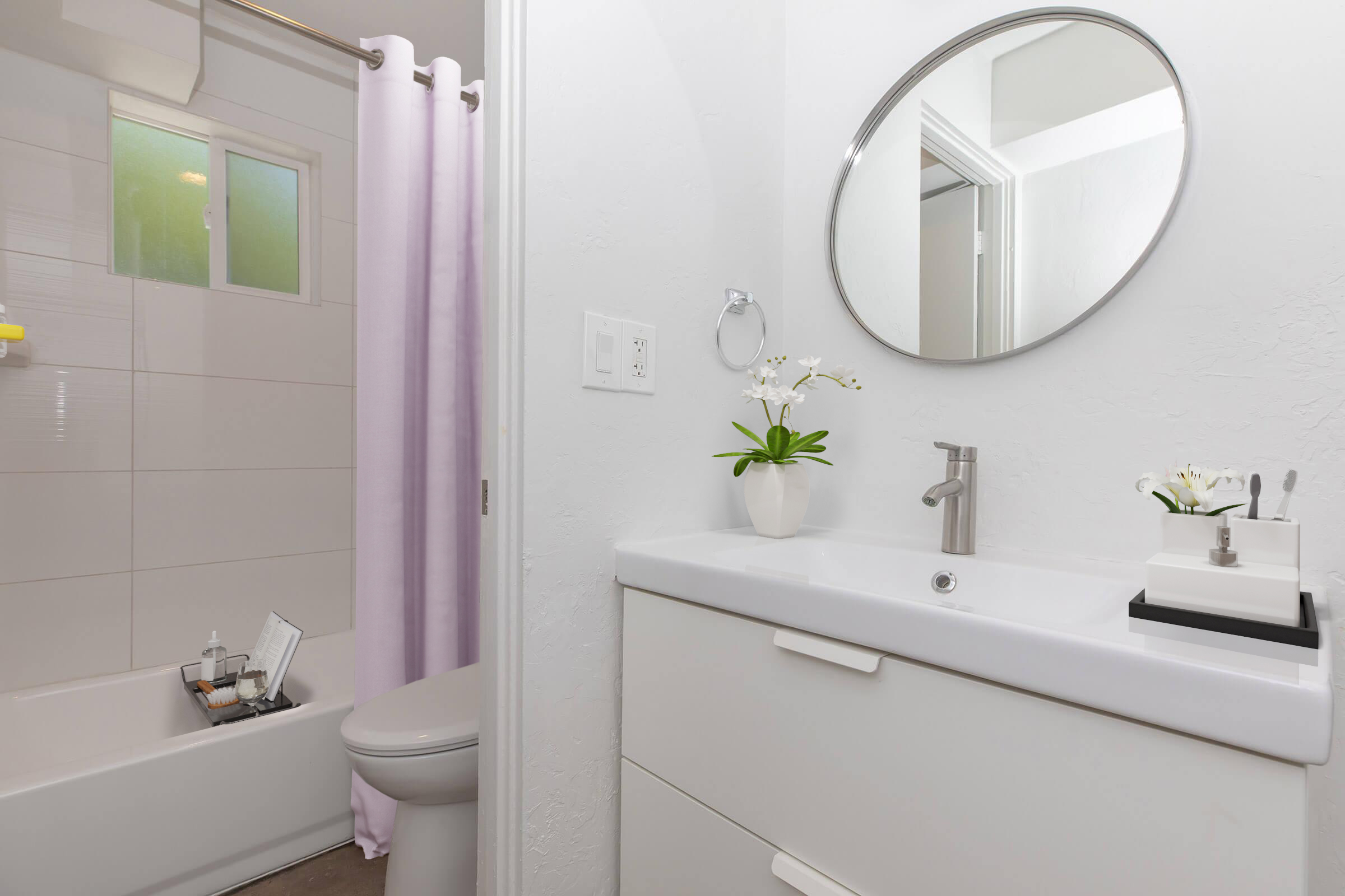 A modern bathroom featuring a white vanity with a sink, a round mirror above it, and a decorative plant. There is a shower area with a light purple curtain, a bathtub, and a toilet. The walls are tiled in neutral colors, creating a clean and contemporary look. Soft natural light enters through a window.