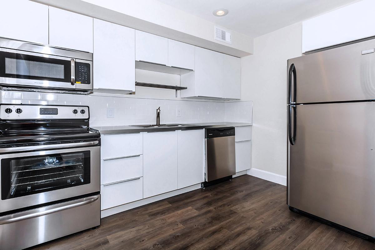a stove top oven sitting inside of a kitchen