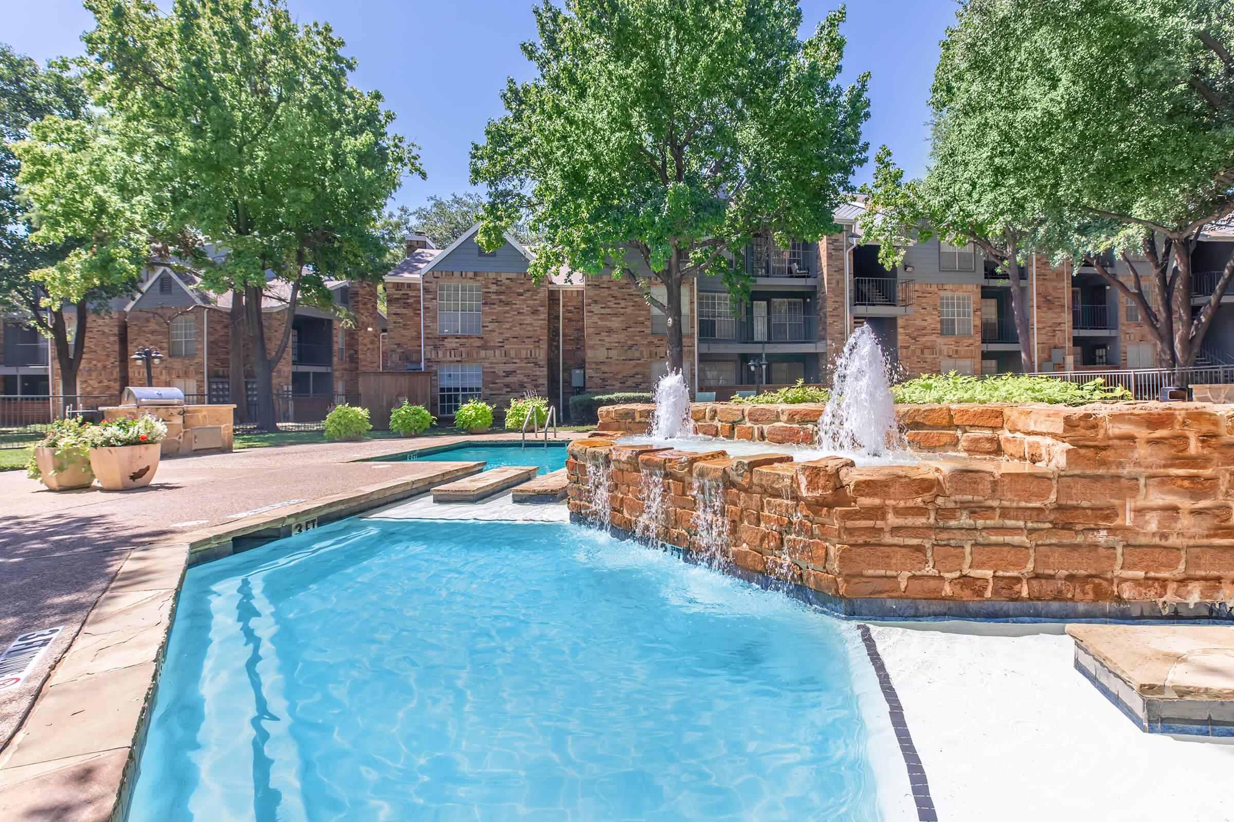 a pool next to a brick building