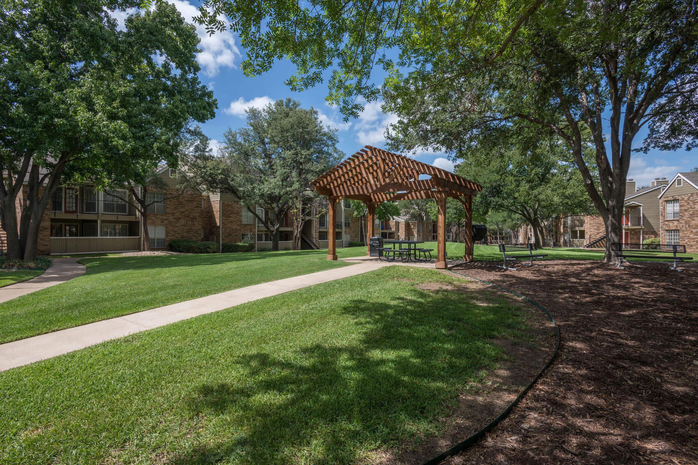 a picnic table under a pergola