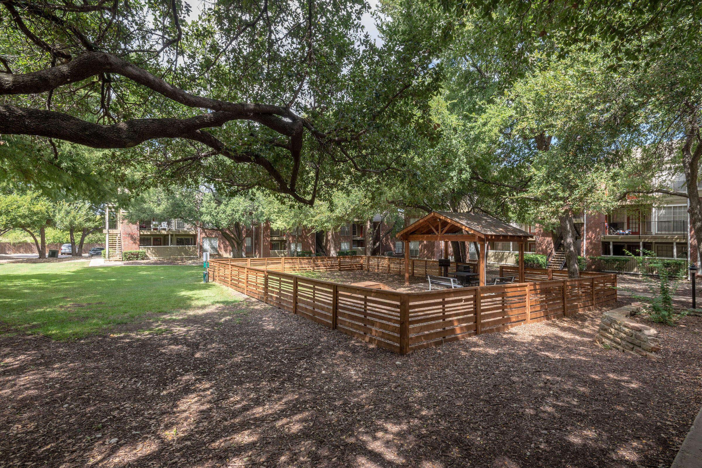 a wooden fenced pet park