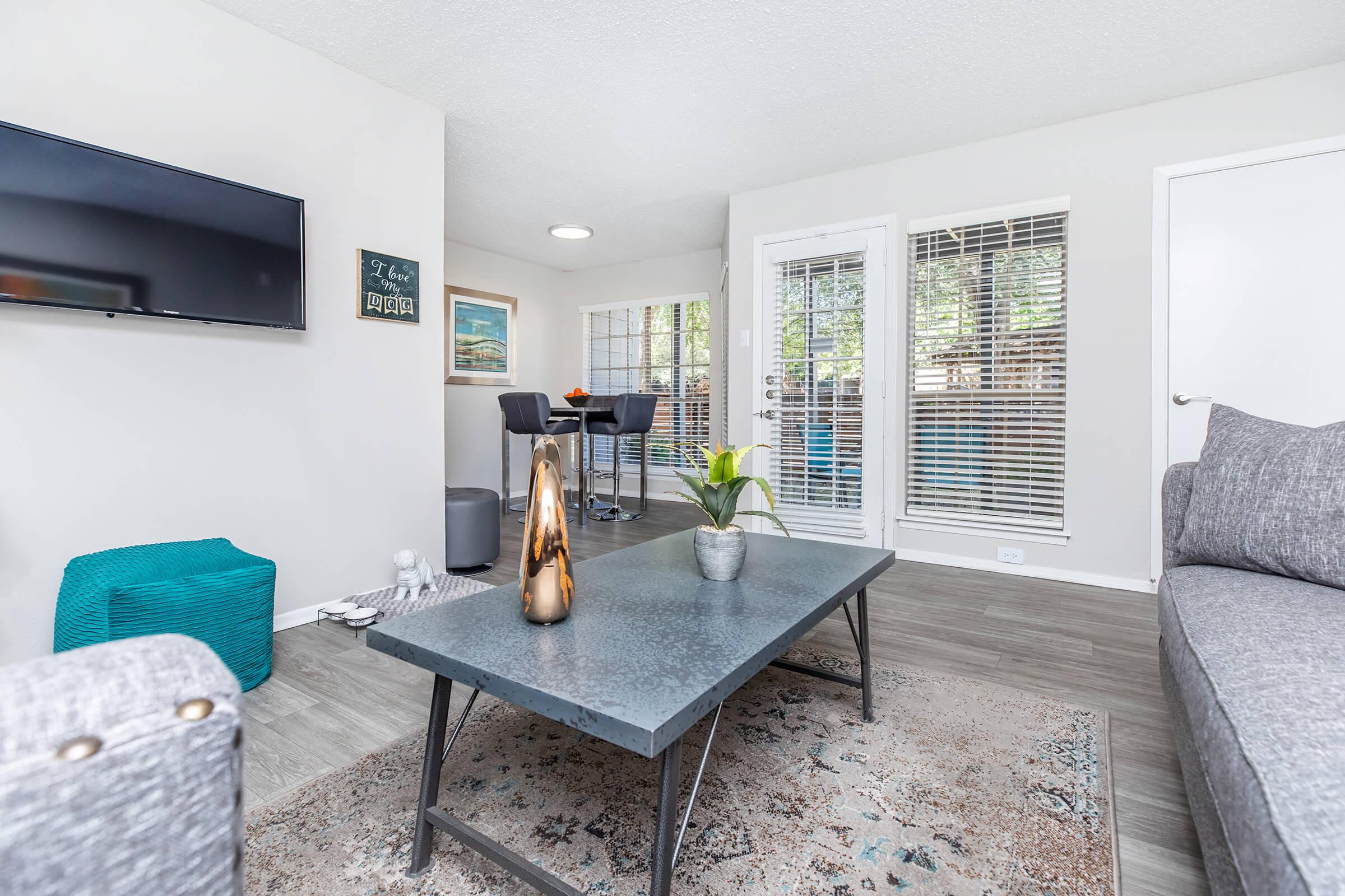 a living room filled with furniture and a large window