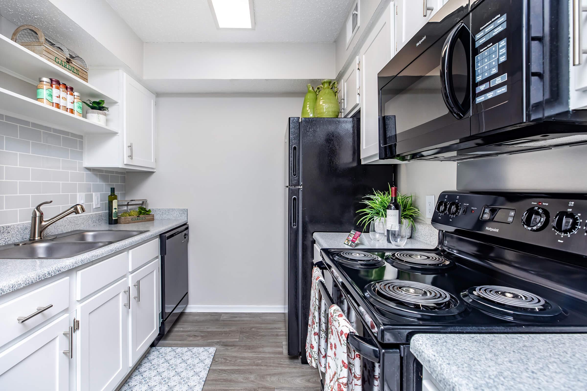 a stove top oven sitting inside of a kitchen