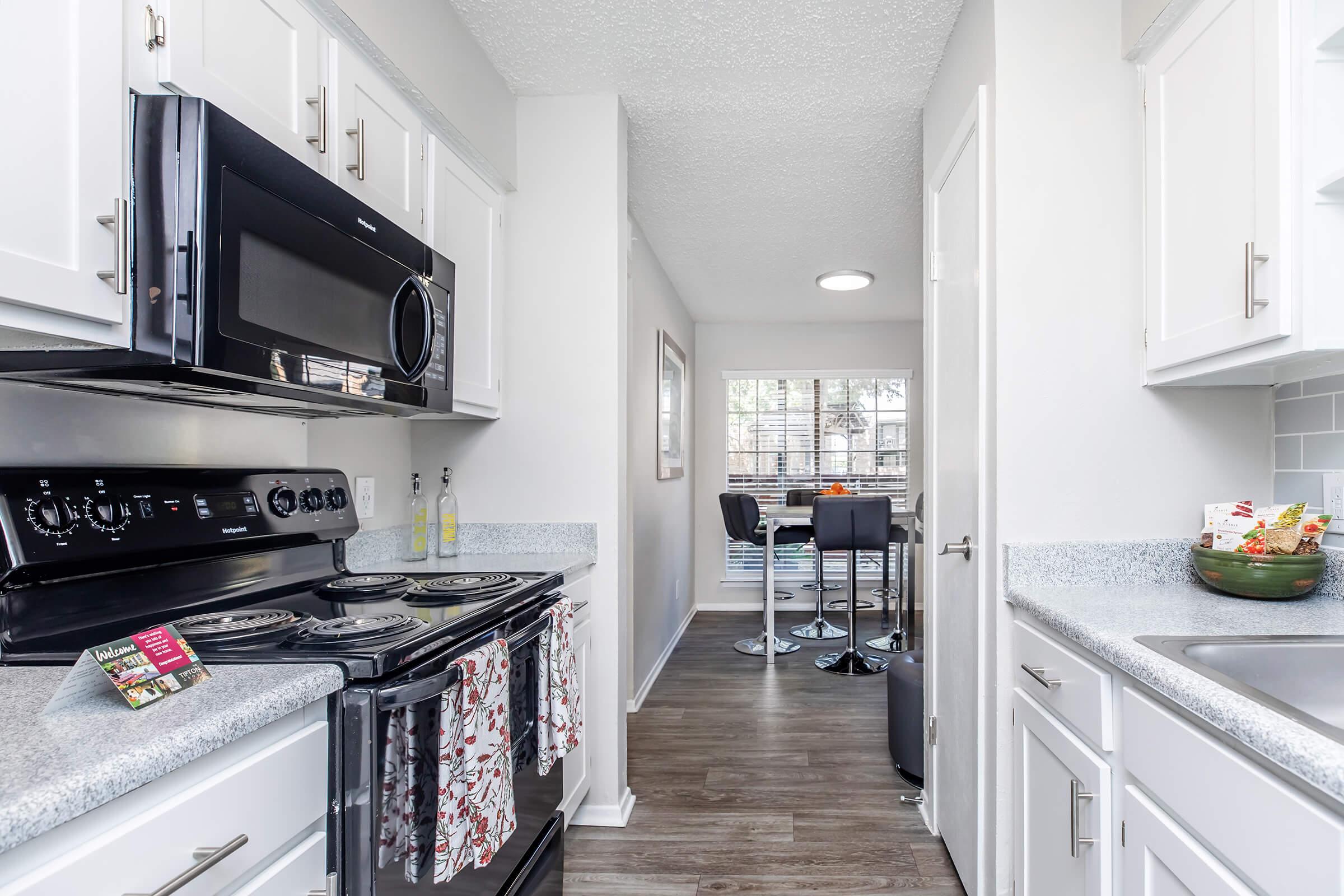 a stove top oven sitting inside of a kitchen