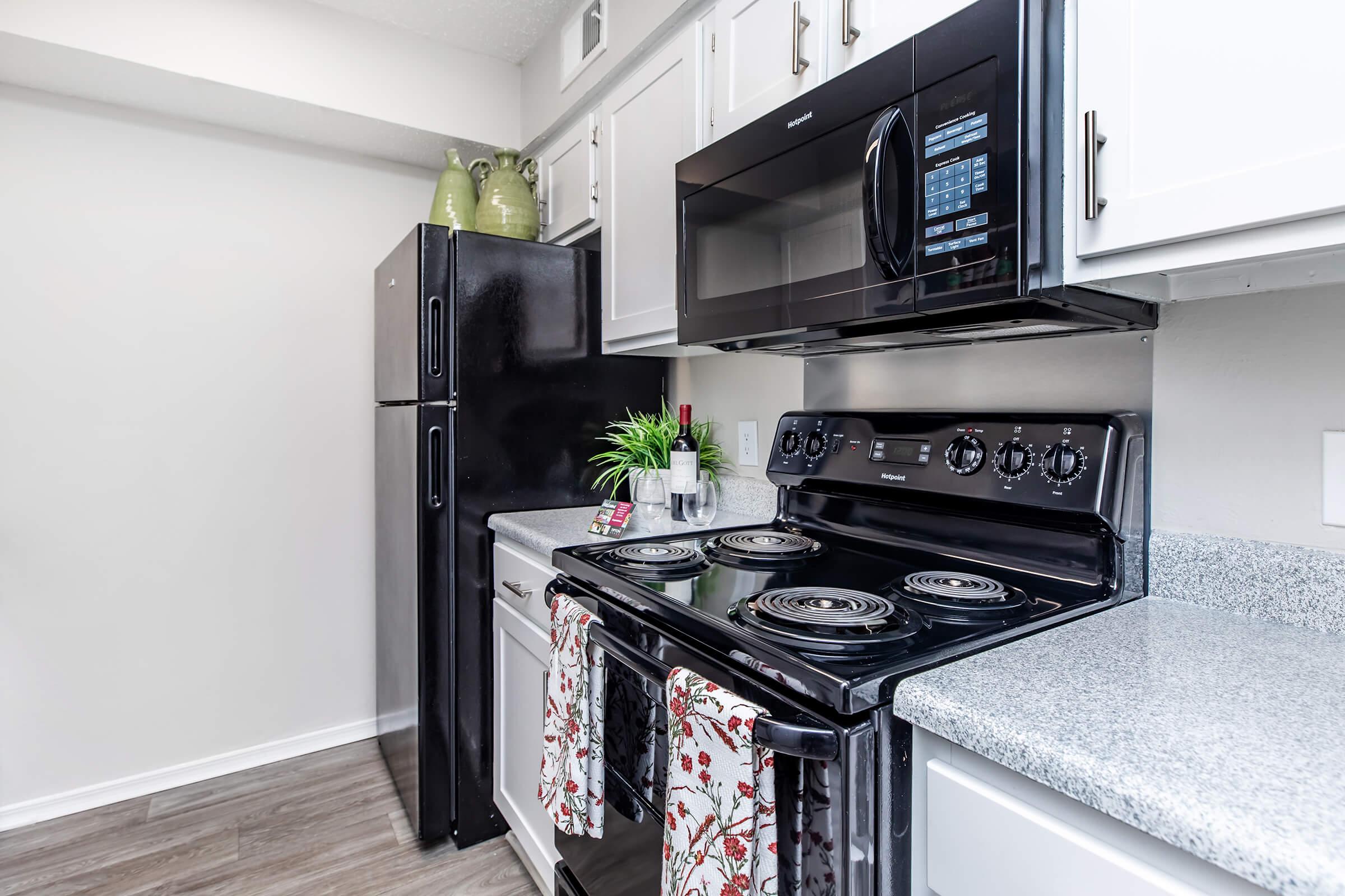 a stove top oven sitting inside of a kitchen