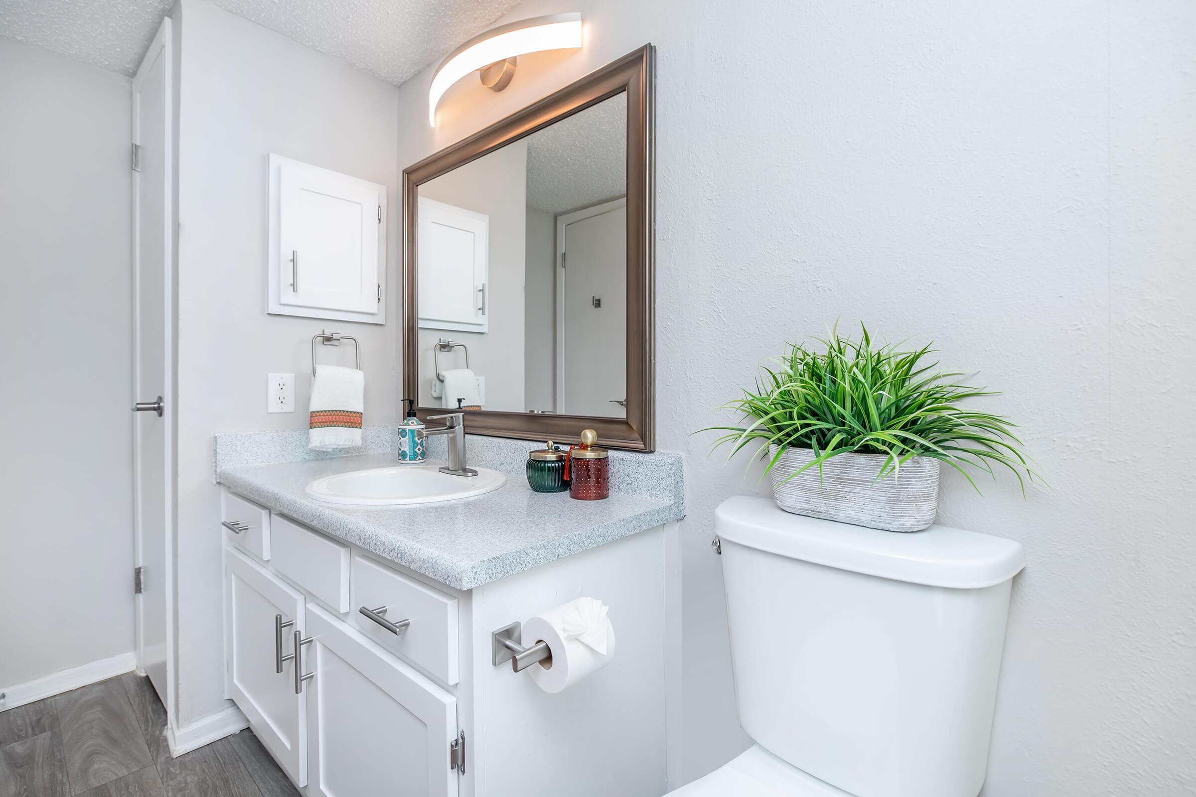 a kitchen with a sink and a mirror