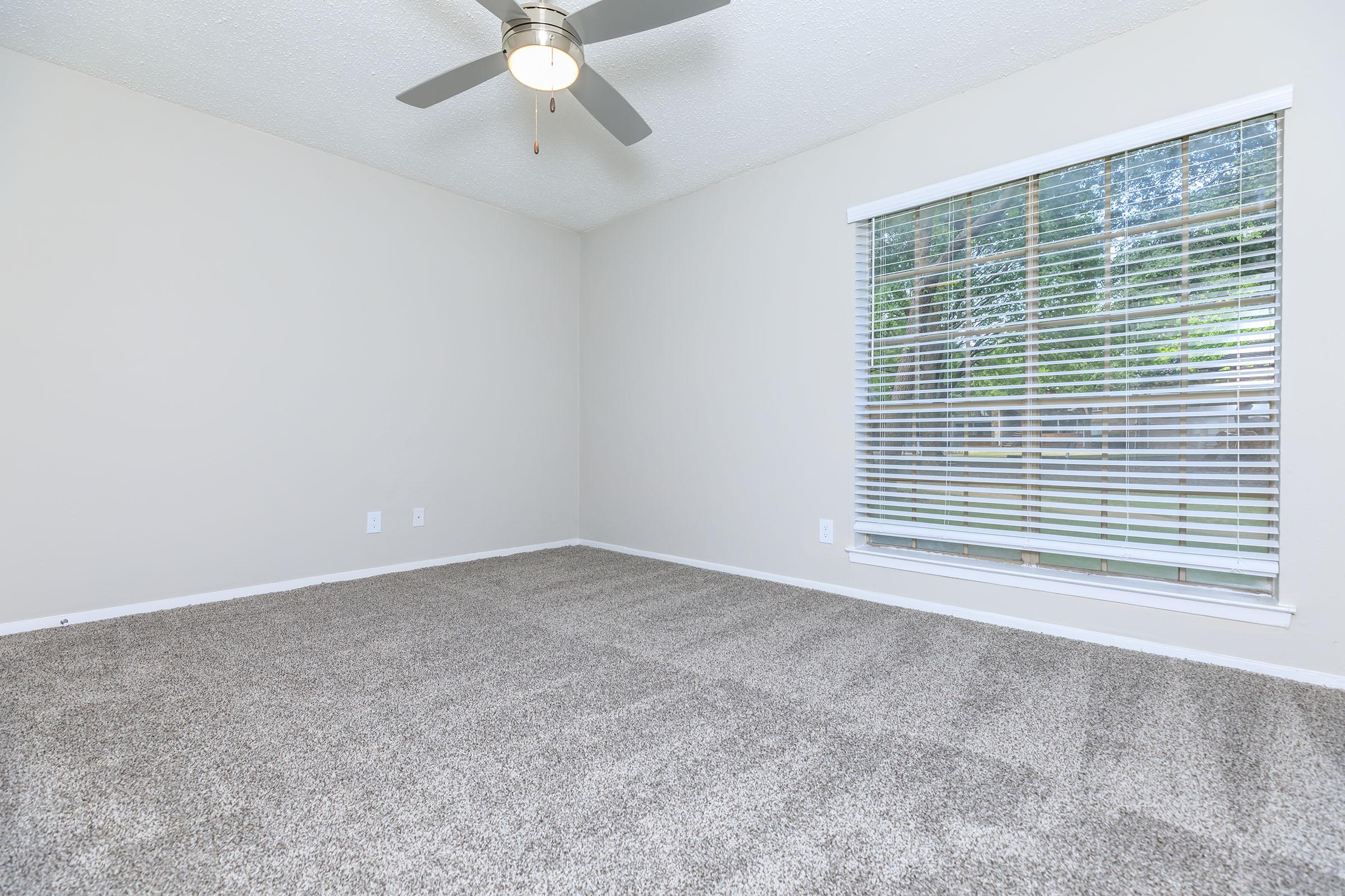 carpeted bedroom with a ceiling fan