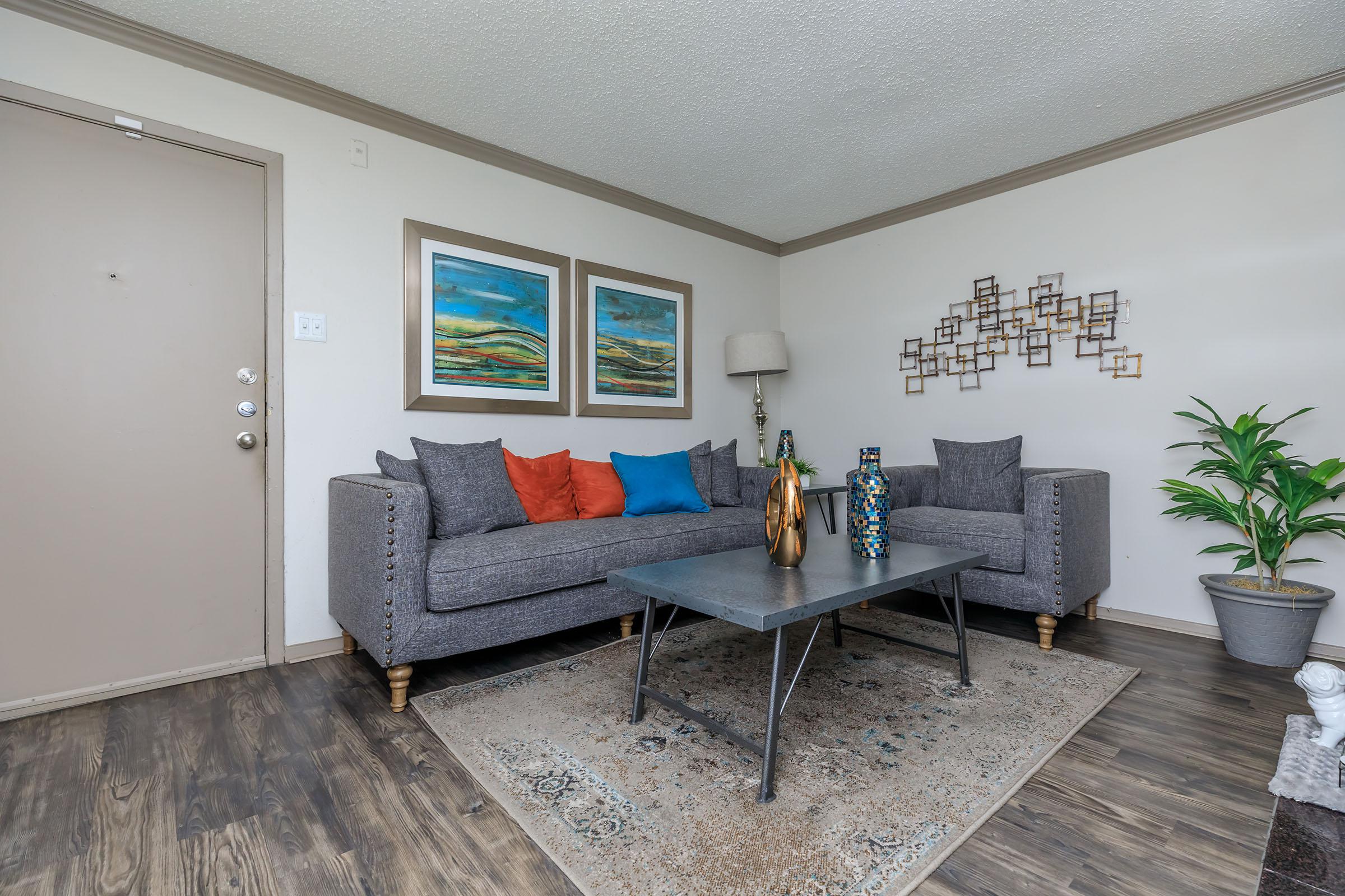 furnished living room with grey couches