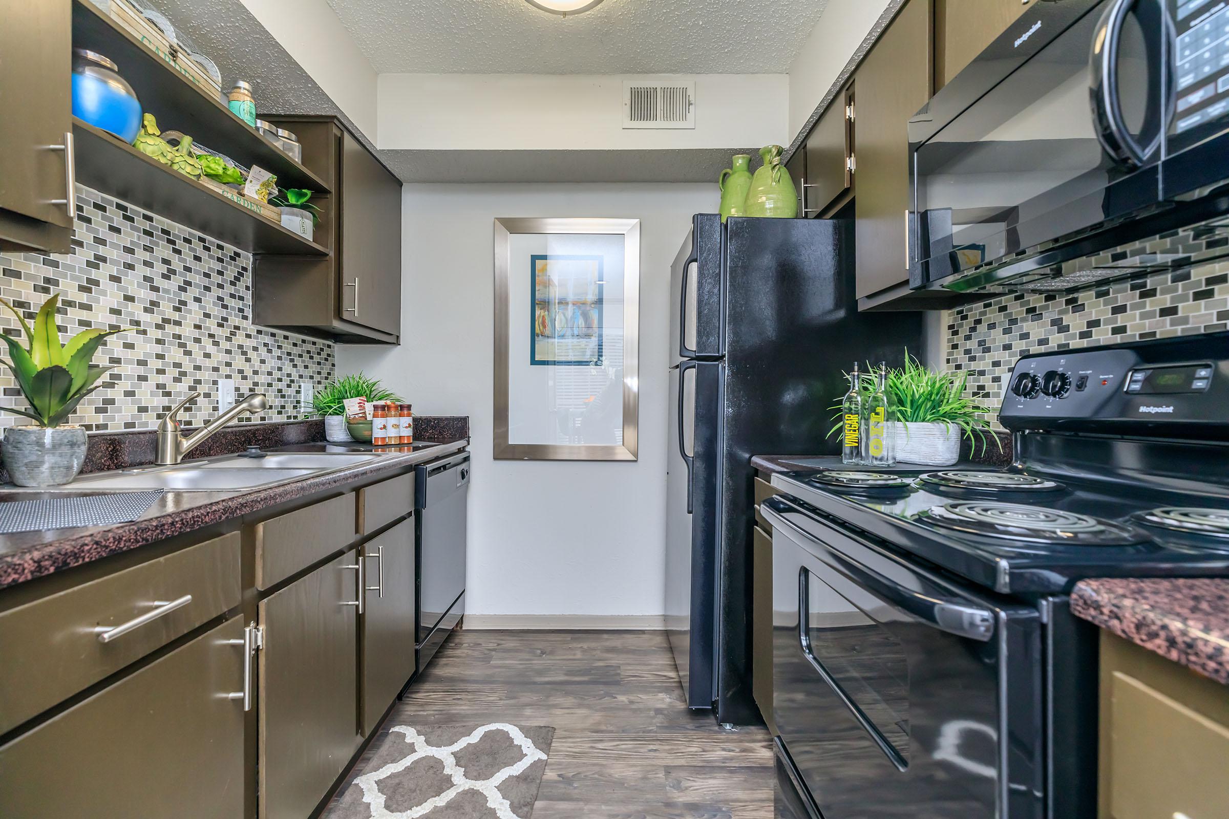 furnished kitchen with black appliances