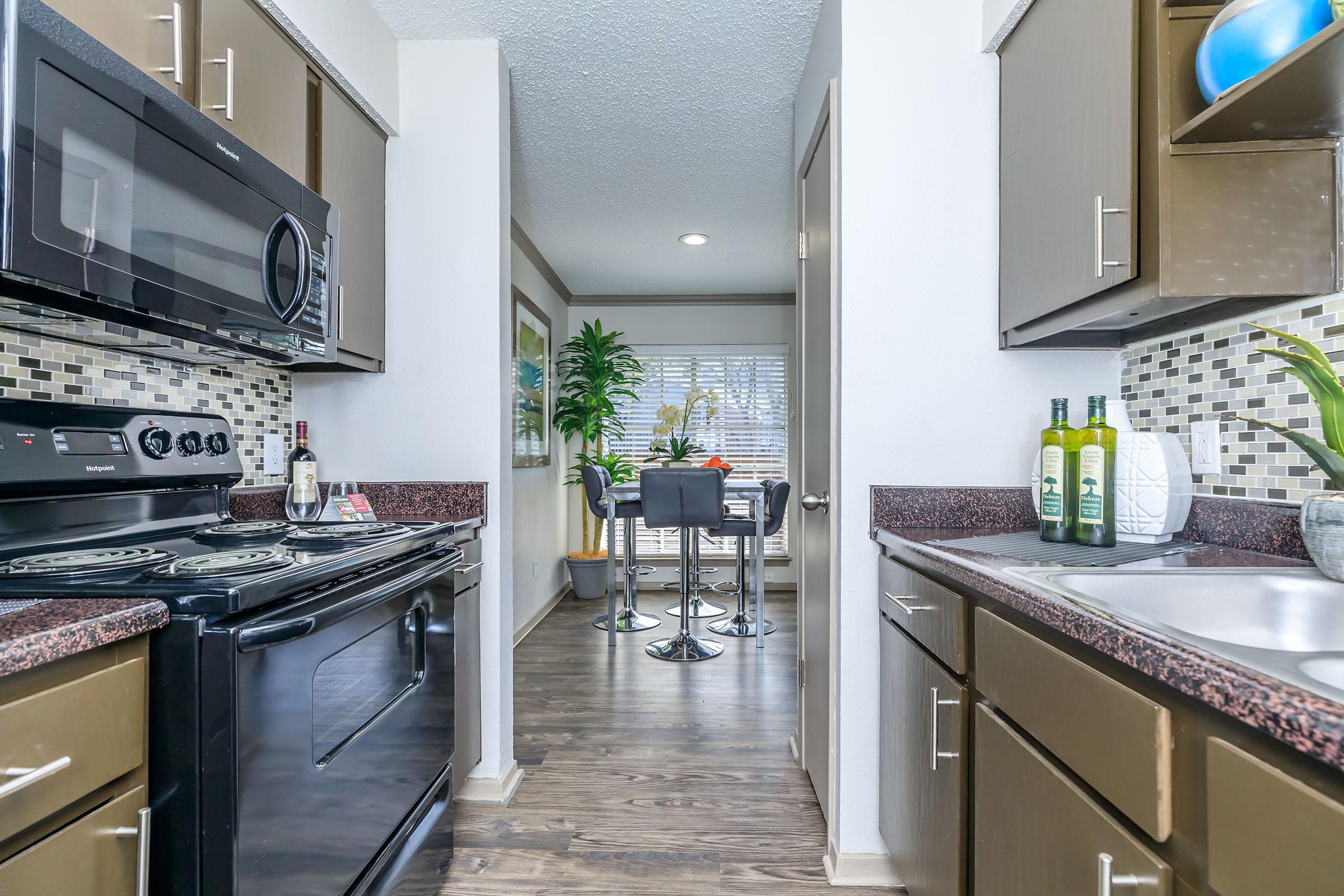 furnished kitchen with wooden cabinets