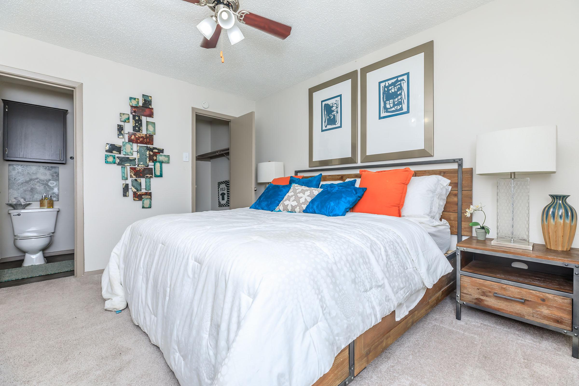 furnished bedroom with a white comforter