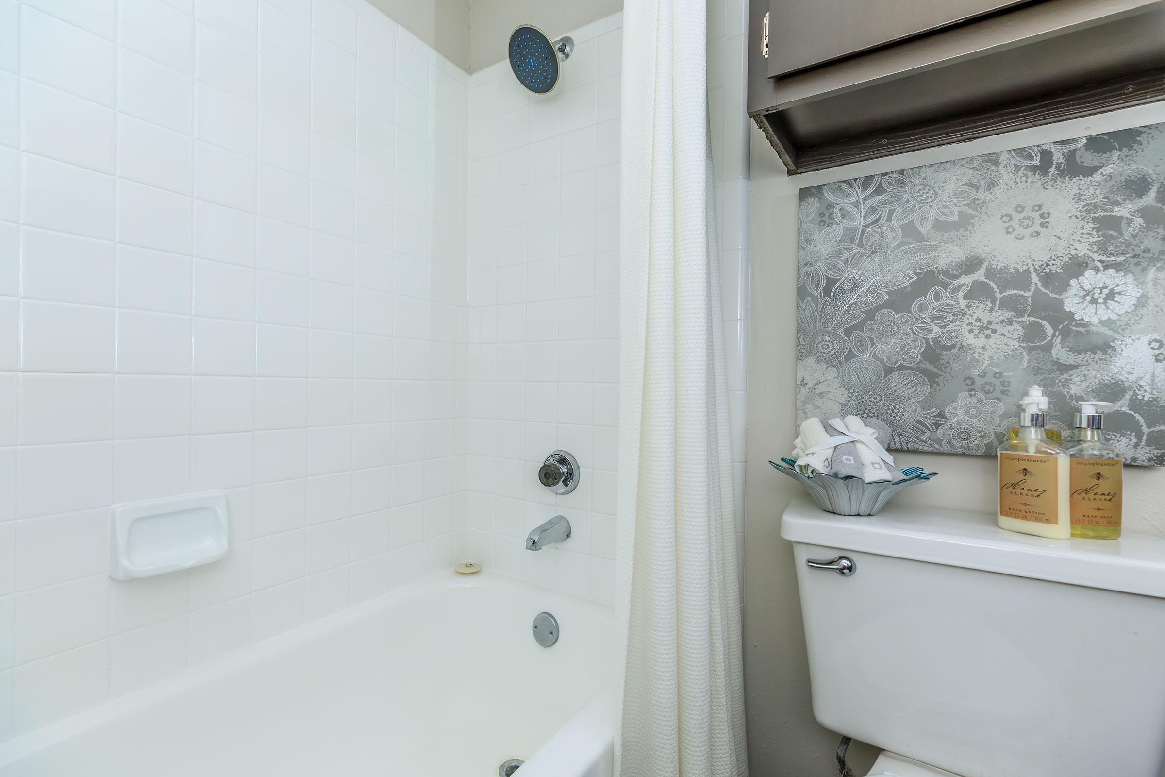 furnished bathroom with a white shower curtain