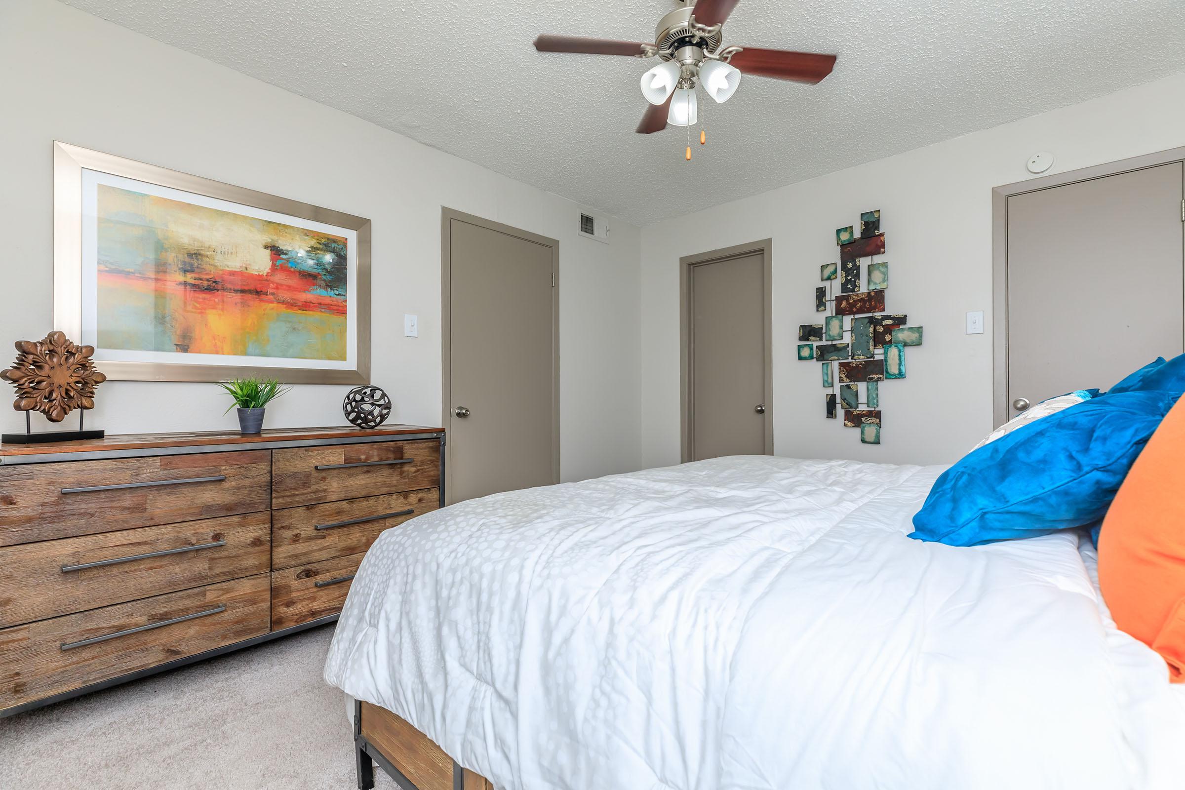 furnished bedroom with a wooden dresser