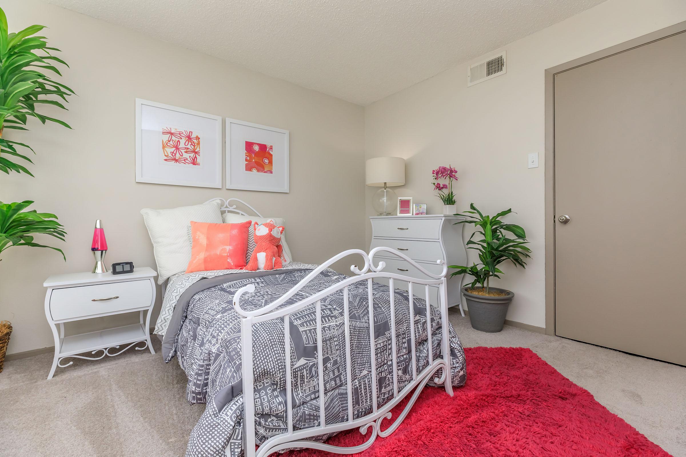 furnished bedroom with a grey comforter