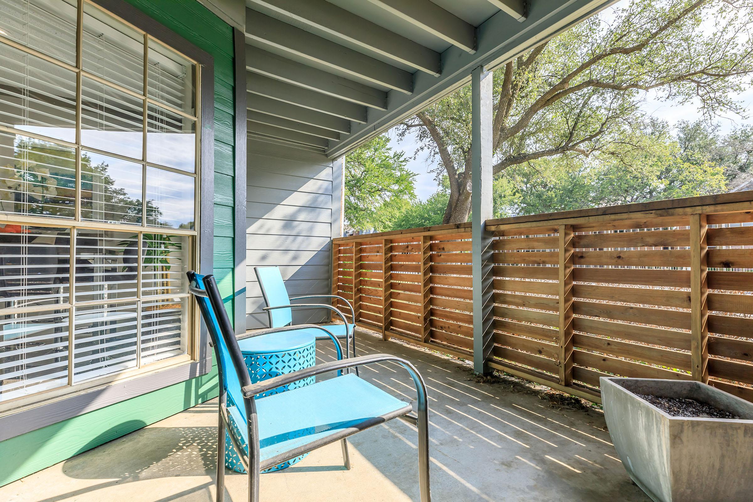 furnished patio with blue chairs