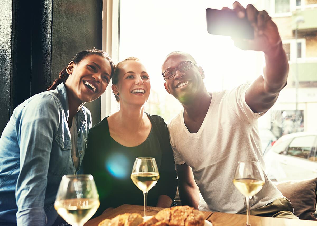 a group of people sitting at a table taking a picture