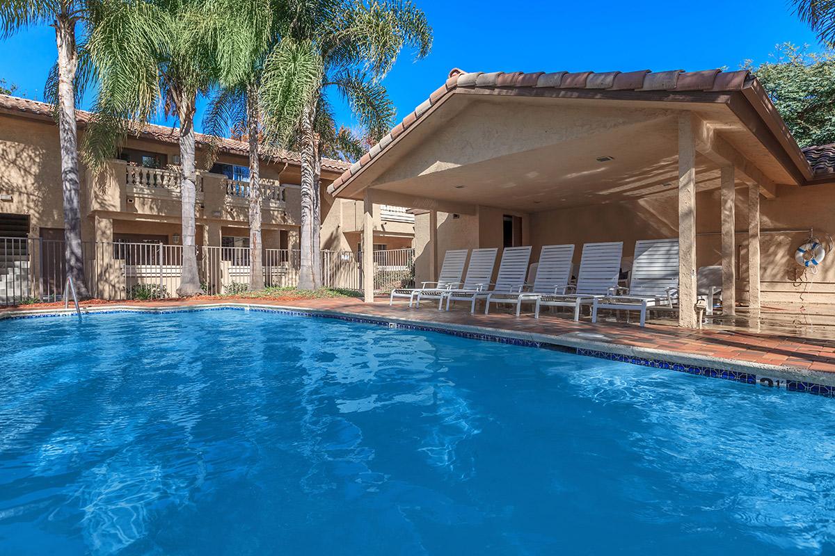 a community pool with covered patio