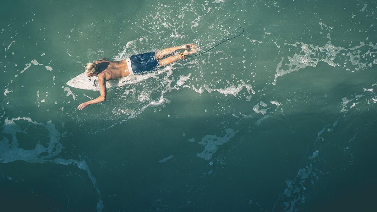 a person riding a wave on a surfboard in the water