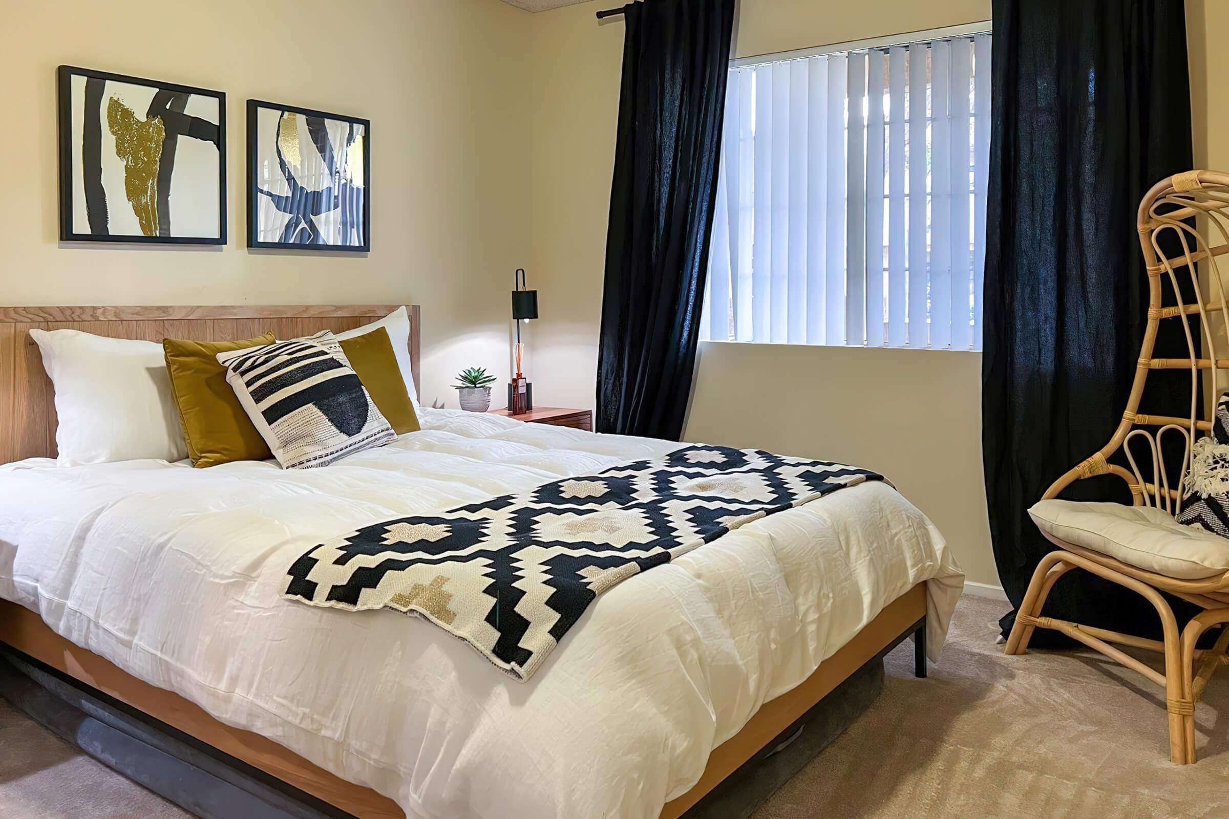 a bedroom with a white comforter