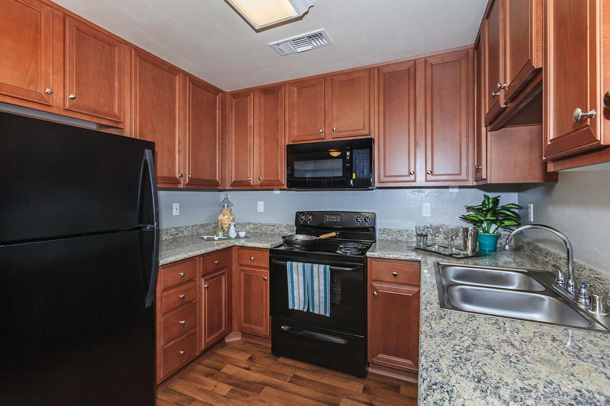 a kitchen with wooden cabinets