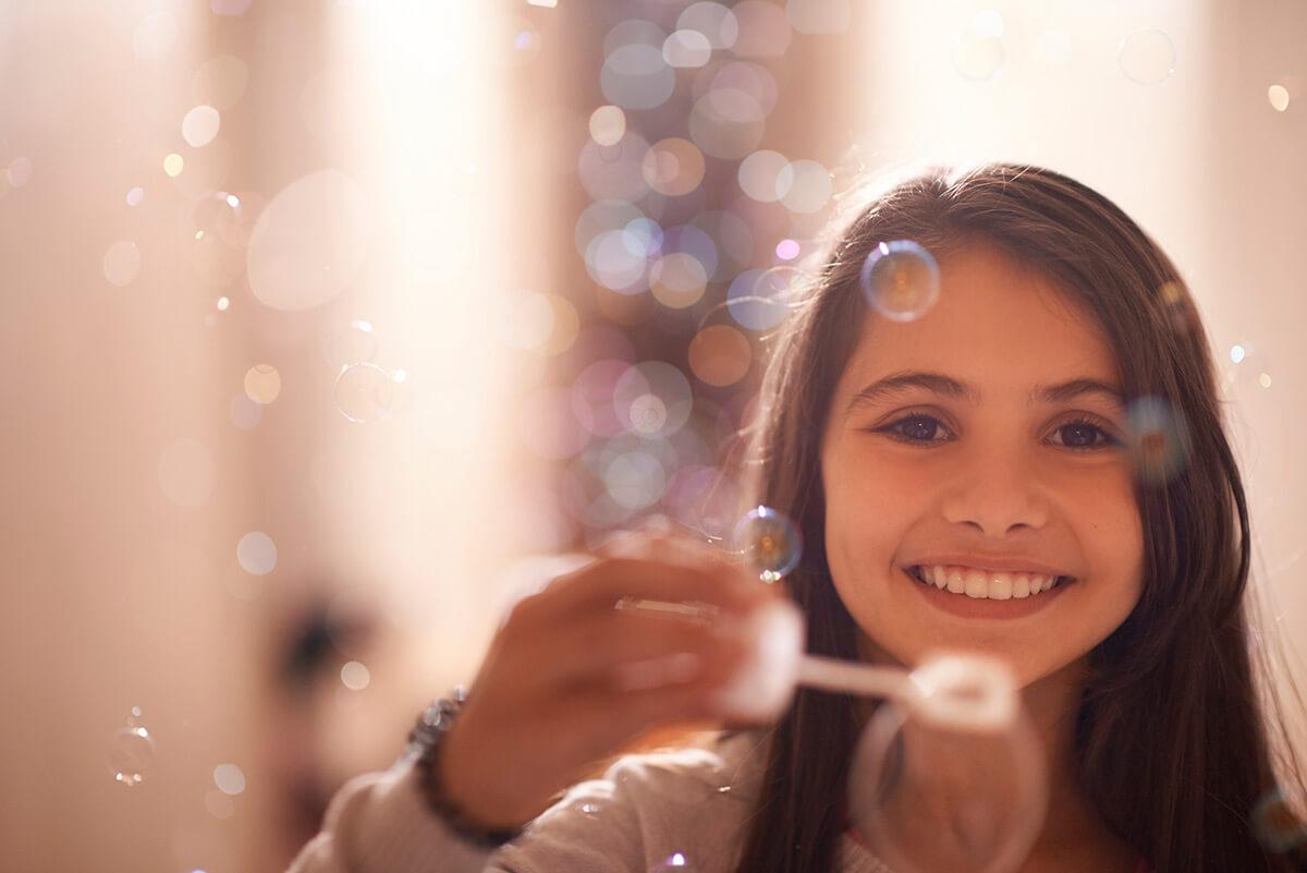 a child blowing bubbles