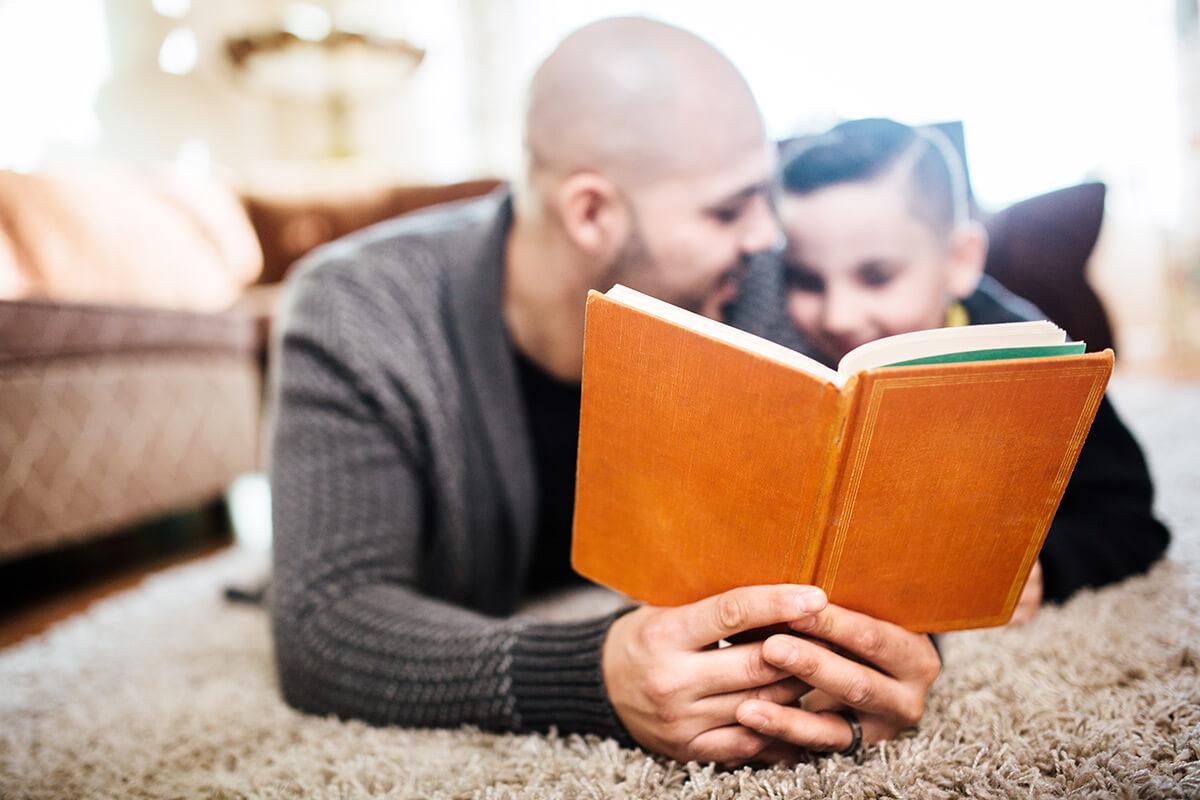 a man and child reading a book