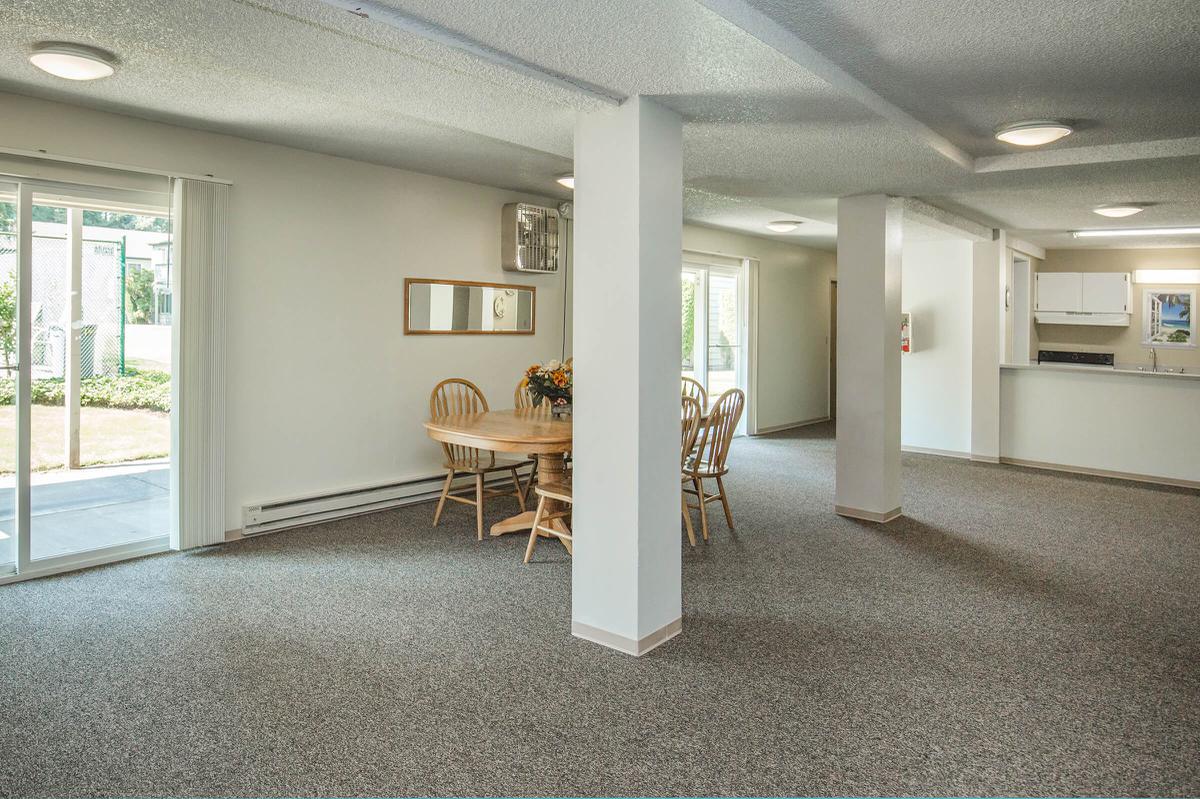 a living room filled with furniture and a large window