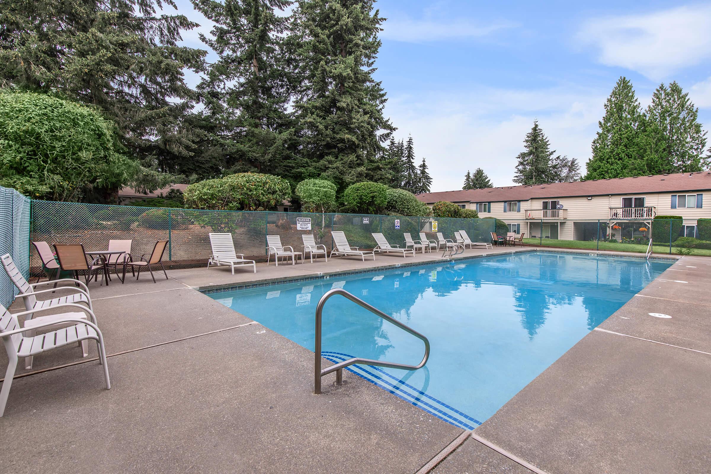 a chair sitting in front of a pool of water