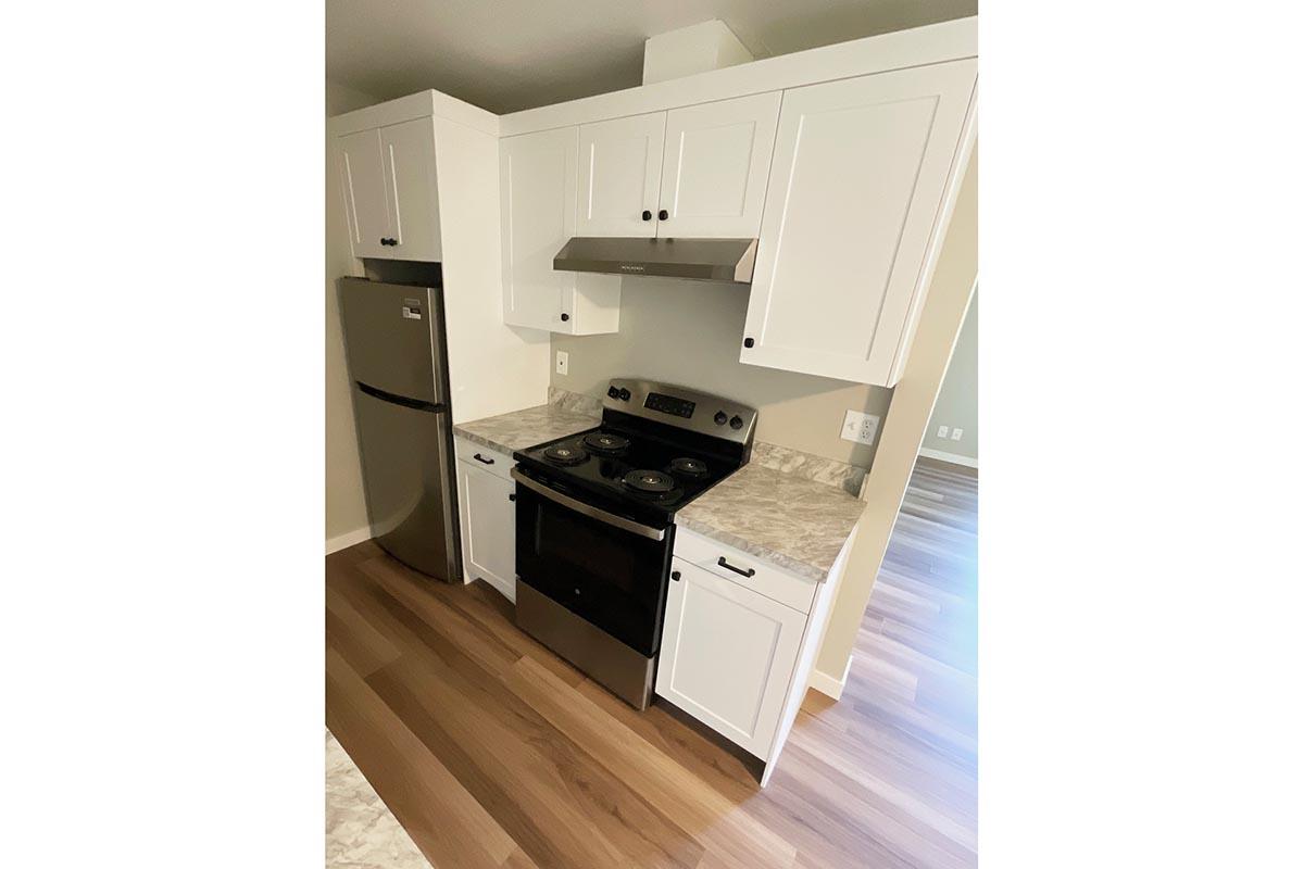 a kitchen with a stove and a refrigerator