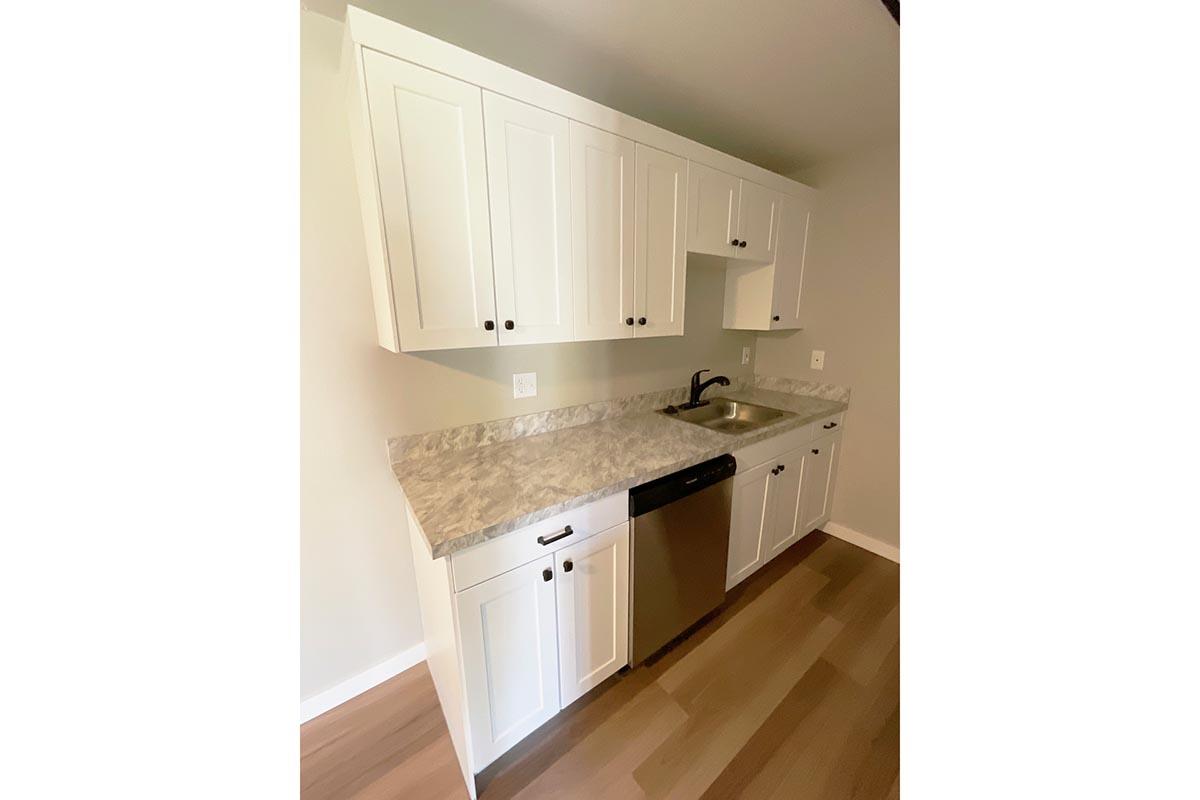 a kitchen with a sink and a mirror