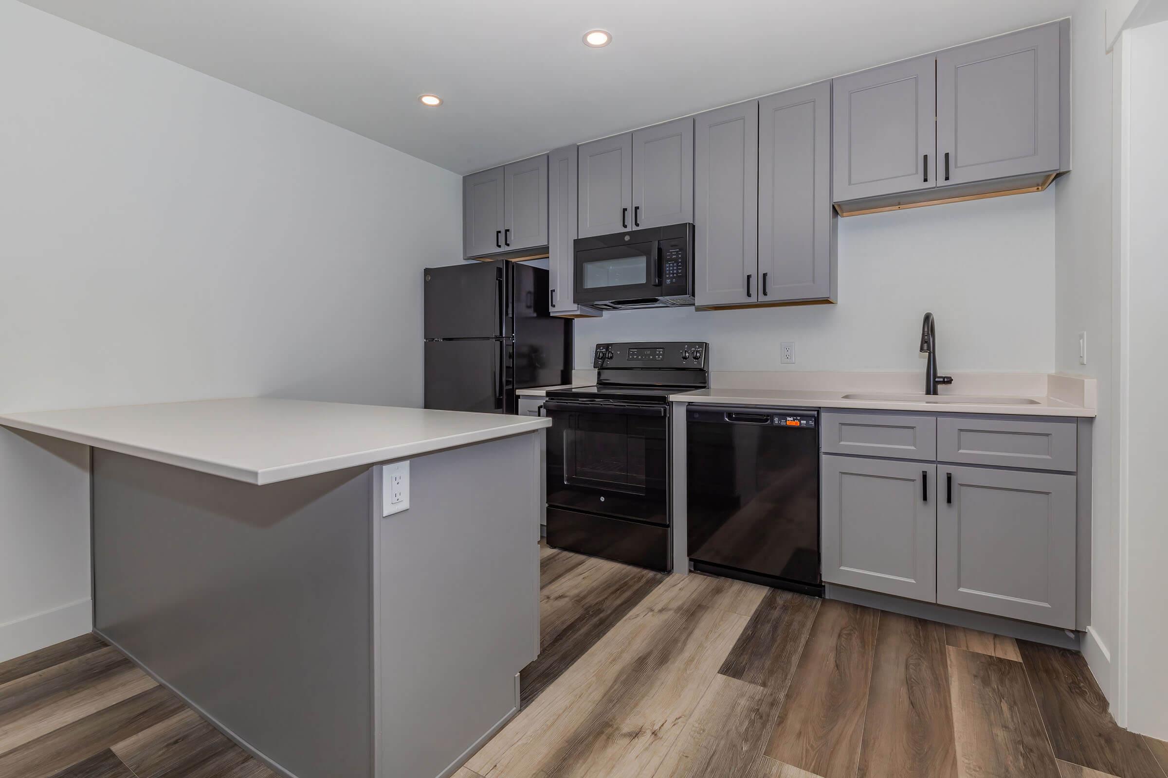 a kitchen with a sink and a refrigerator